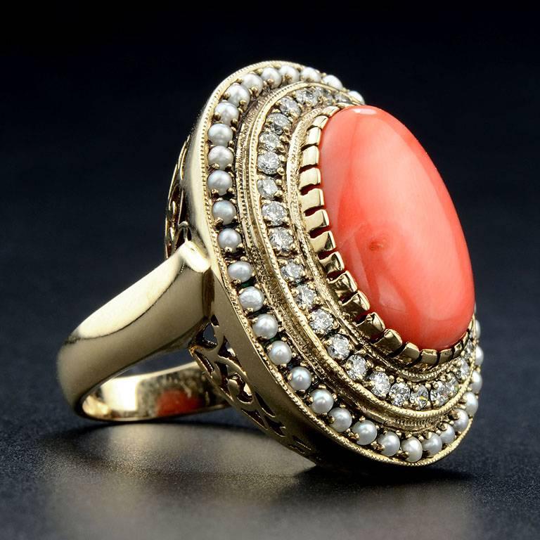 Natural Coral 7.5 Carat surrounded by Tiny Fresh Water Pearl and Diamond 0.48 Carat outlined.  The ring was made of 14K Yellow Gold in size US#7