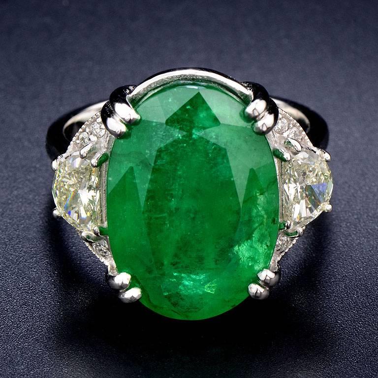 This contemporary style Ring set with Zambian Emerald weight 11.02 Carat graced by 2 half moon Diamond 0.60 Carat and small melee Diamond 0.05 Carat.

The ring was made of 18K White Gold in size US#7