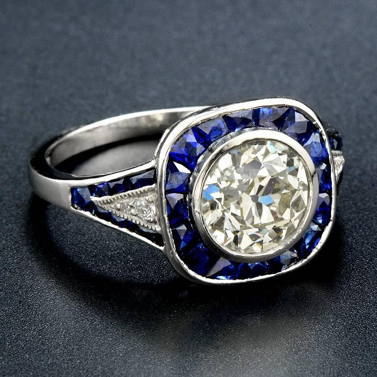 HKD (Diamond Laboratories Canada) Certified 1.61 Carat Old European Cut (K Color VVS2 Clarity) set on Platinum 950 Ring.  Surrounding by French Cut Thai Blue Sapphire Total 2.90 Carat channel set and small melee Diamond 0.04 Carat.

The ring was