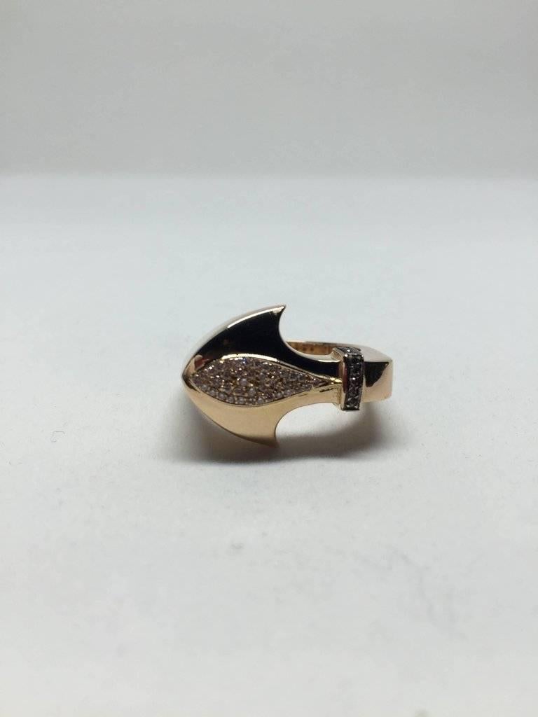 Hand made 18K rose gold spear ring with white and brown diamonds. The spear figure represents 'achieving a goal'.