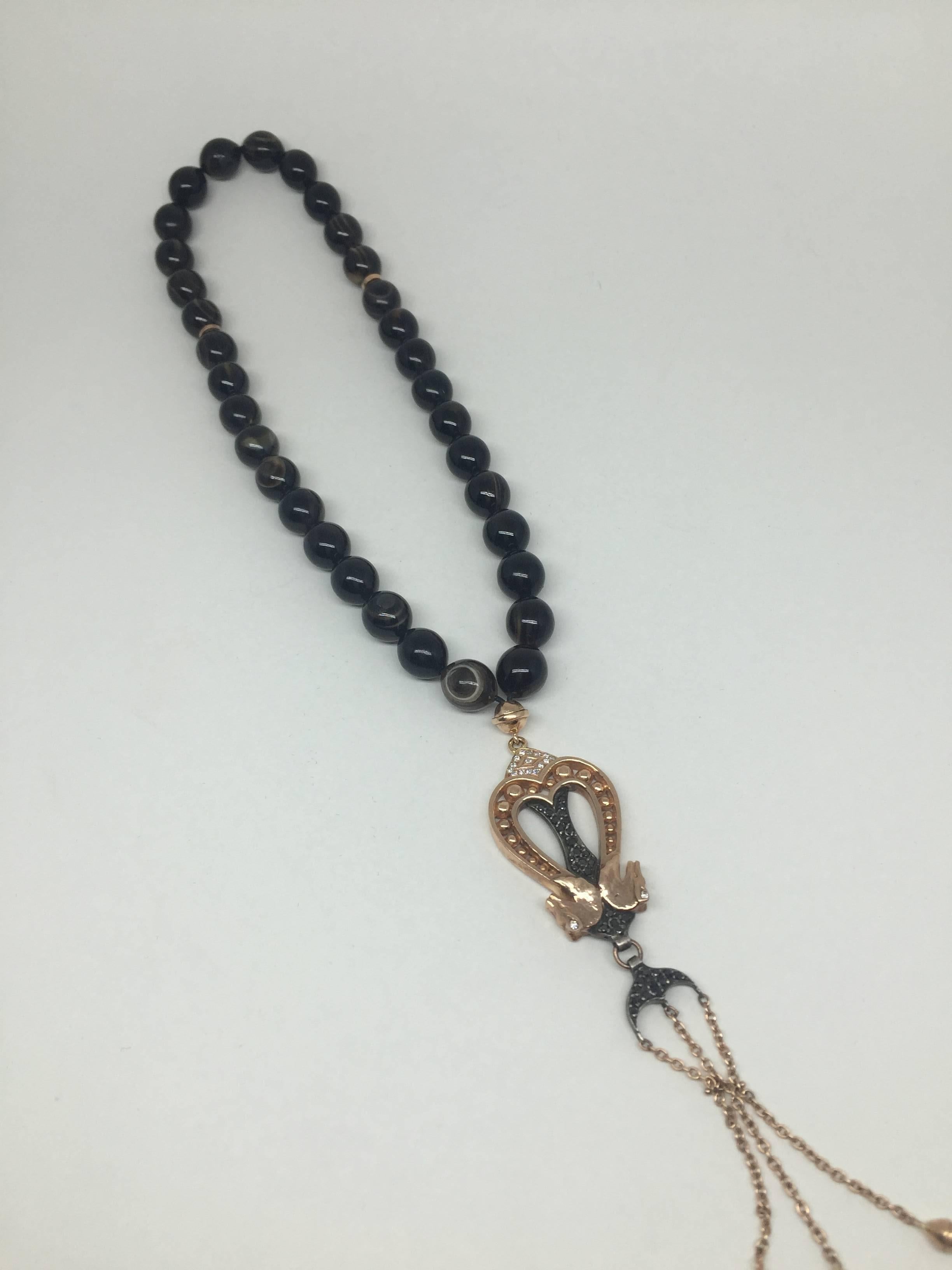 Tortoise shell stone rosary  14K rose gold with 0.17 ct diamond and 0.62 ct black diamond details. 

The double-head horse figure represents the 'noble character'.