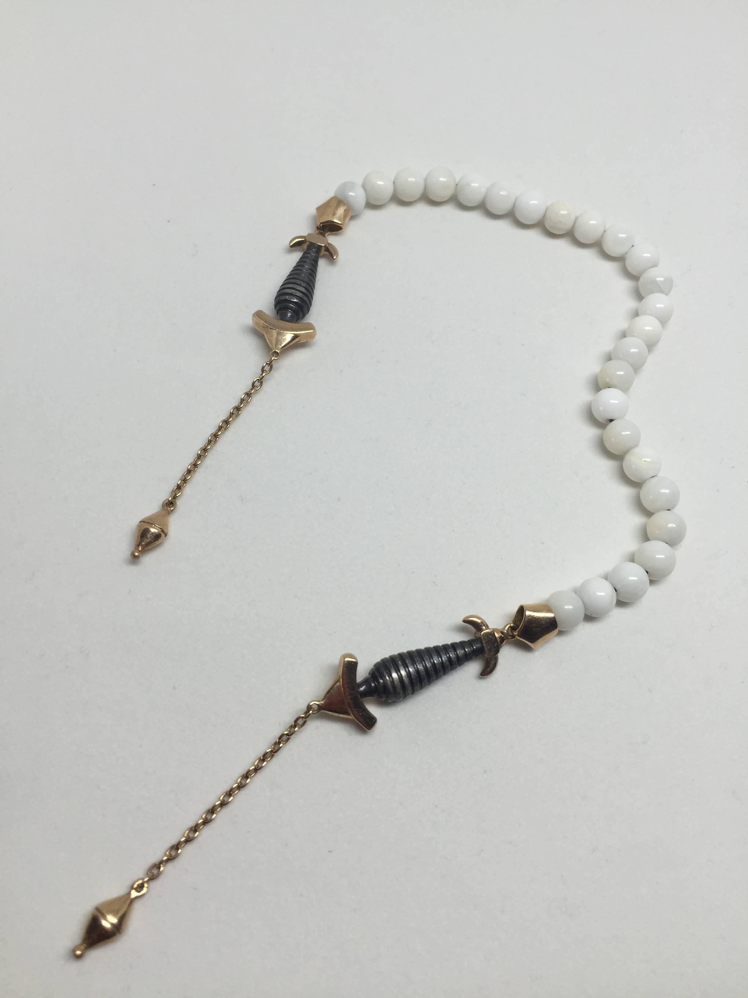 18K Gold and 925 sterling silver sea shell rosary. The sword hilt figure symbolises protection.