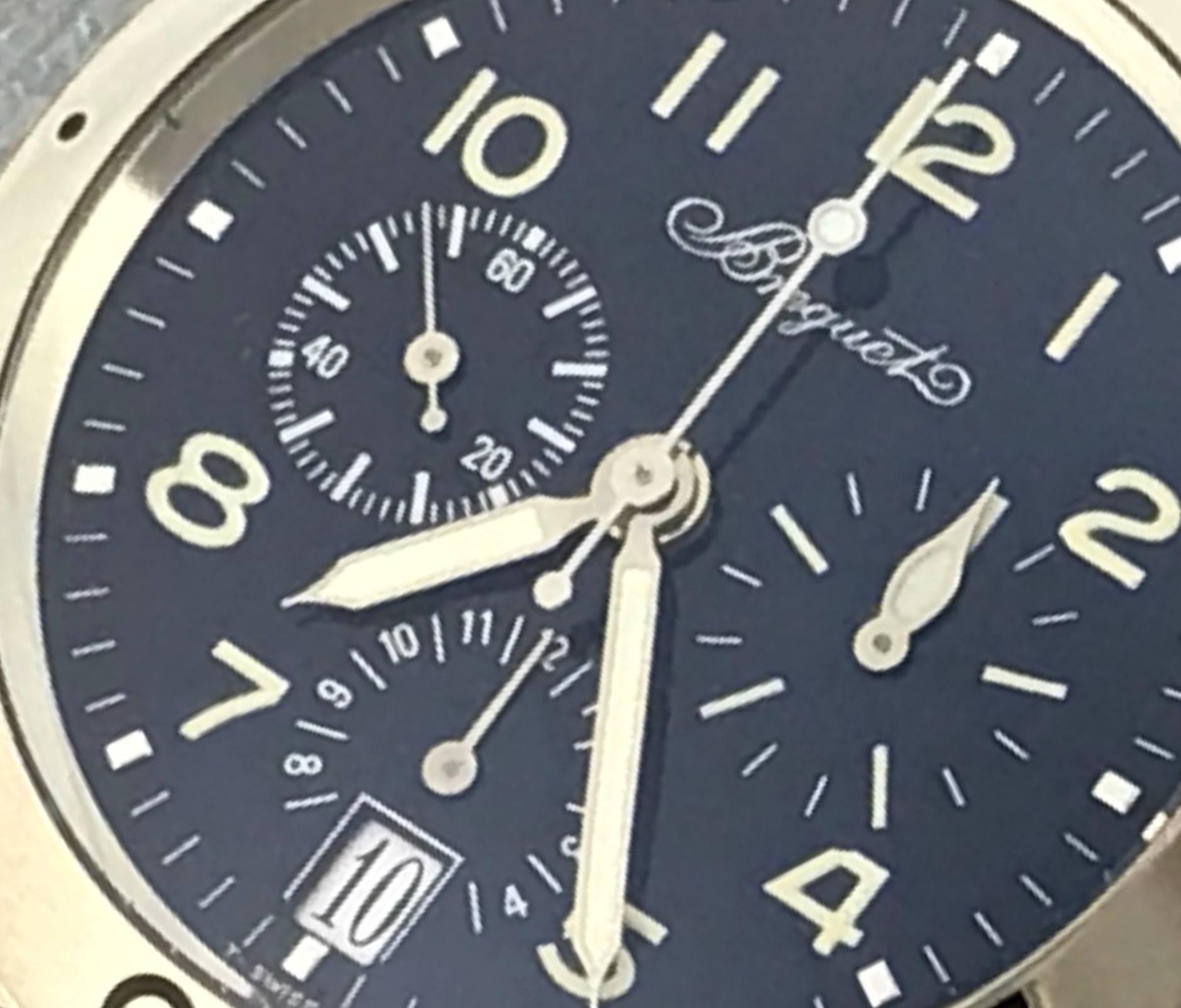 Breguet Transatlantic Chronograph Model 3820BB.B2.3W6 certified pre-owned men's automatic wrist watch.  Featuring a dark blue dial with luminous arabic numerals encased in 18k white gold, screw down crown and measuring 39mm. Black strap with 18k