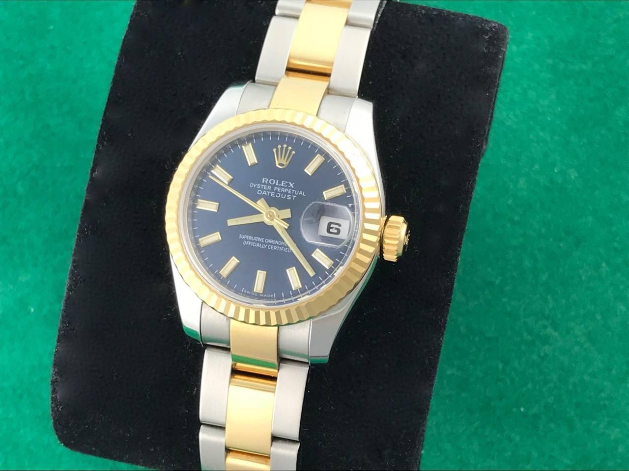 Ladies Rolex Datejust Ref 179173.  Certified pre-owned and ready to ship. Oyster Perpetual, Automatic winding movement.  Blue Dial with yellow gold and luminous hour markers. Features a Stainless Steel case with 18k Yellow Gold fluted bezel (26mm