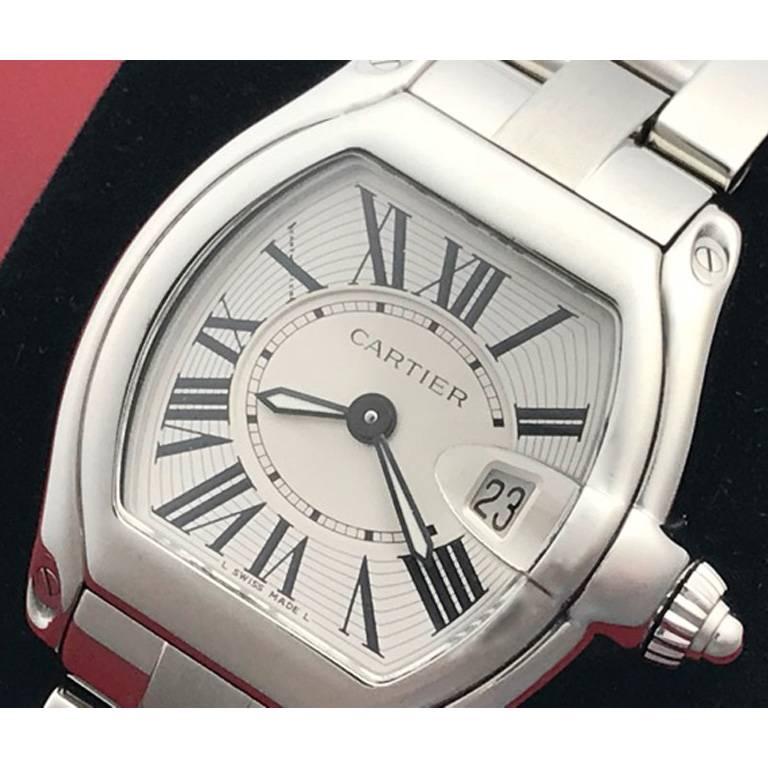 Manufacturer: Cartier
Model Name: Roadster
Model Number: Model W62016V3
Gender: Ladies
Movement: Quartz with Date
Case: Stainless Steel rectangular tonneau style case (30x35mm)
Bracelet: Stainless Steel Catier bracelet with deployant clasp.
Dial:
