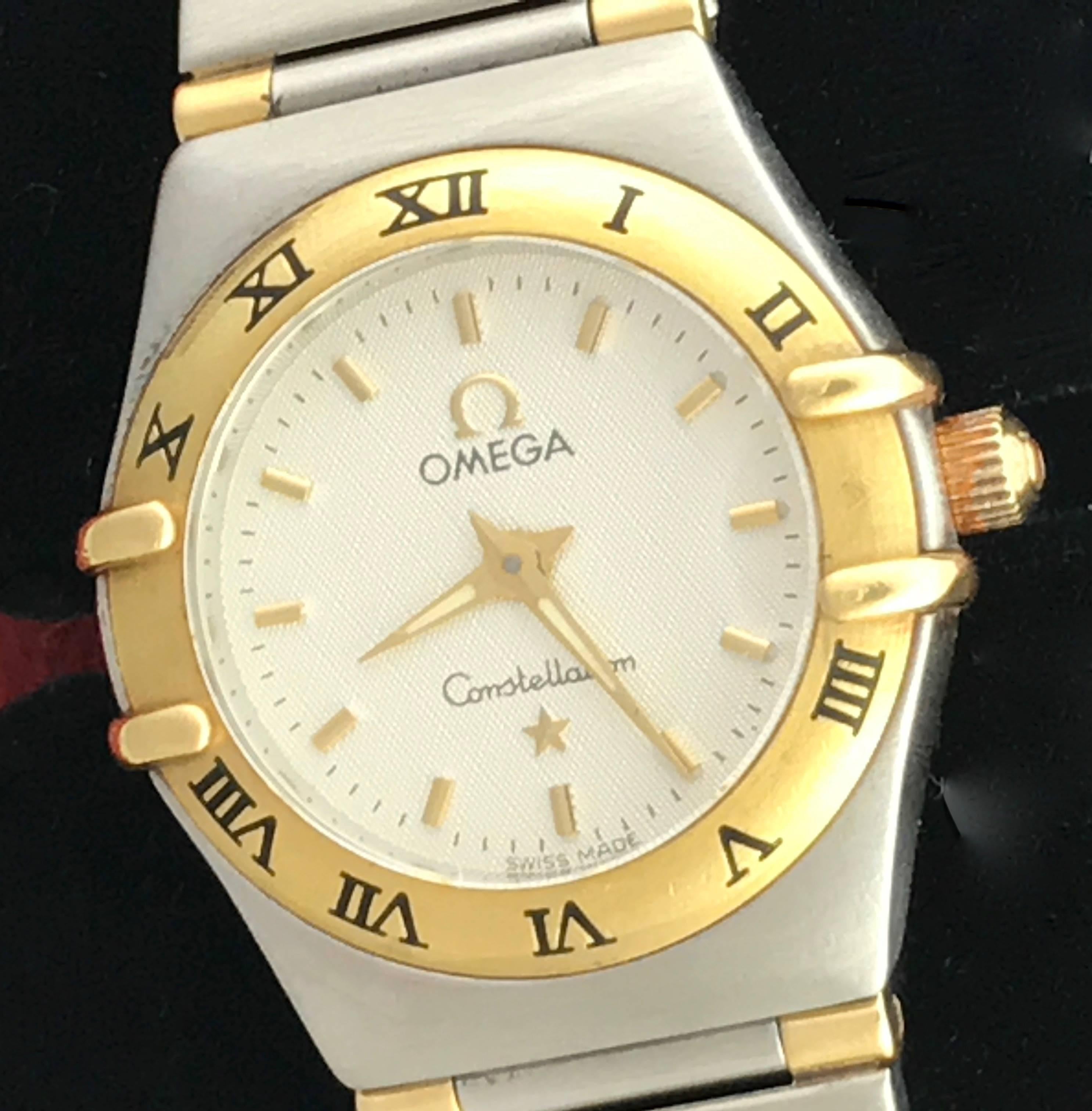 Omega Constellation ladies quartz pre-owned wrist watch. This beautiful classic Omega features a silvered dial with polished hour markers and classic stainless steel case with 18k bezel adorned with black roman numerals. Measures 22mm. This watch is