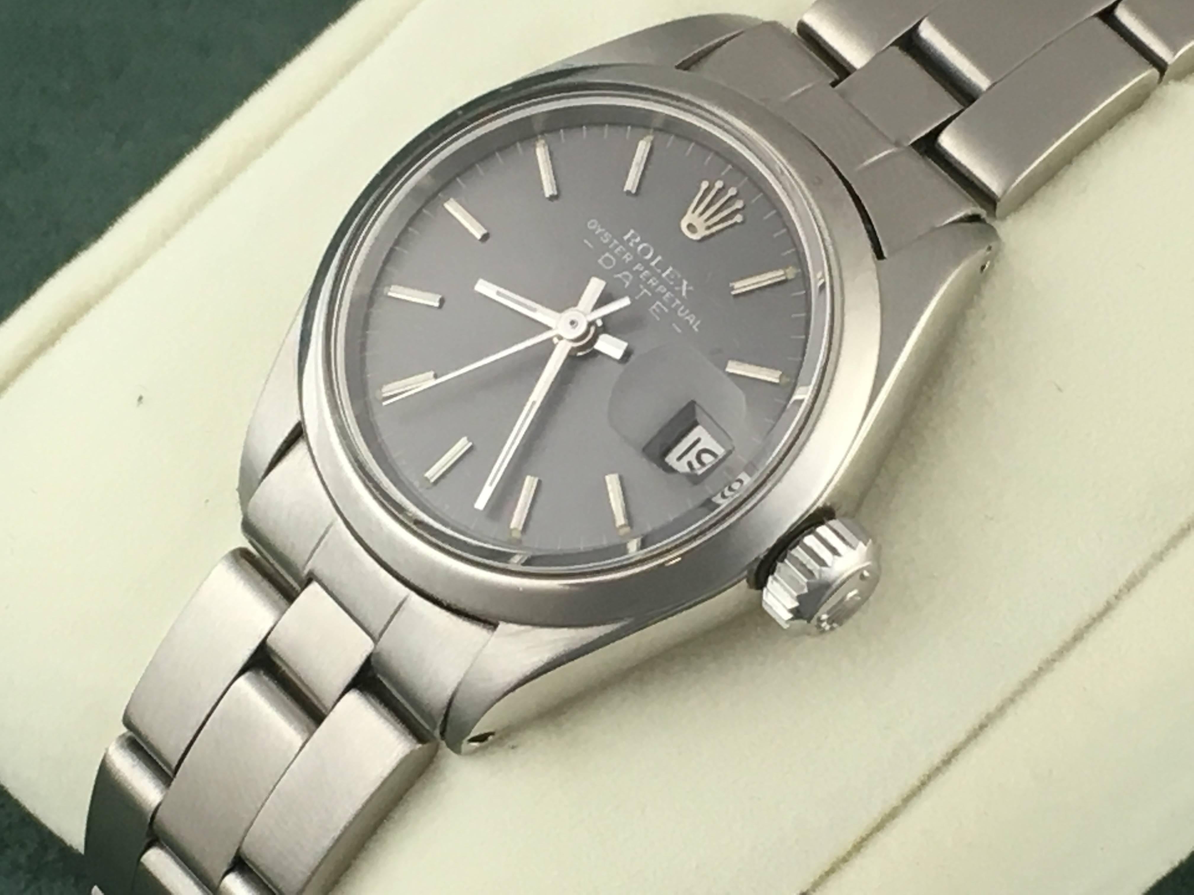 The Rolex Date Model 6917 pre-owned ladies automatic wrist watch. Rich gray dial with polished hour markers and stainless steel case with smooth bezel. Measures 25mm. Features the classic Rolex stainless steel oyster bracelet. Box, instruction