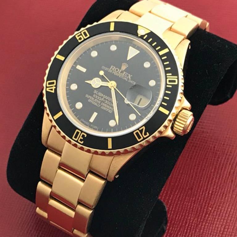 Rolex Submariner Mens Model 16808 18K Yellow Gold Wrist Watch.  Certified pre-owned, as new and ready to ship.  Very clean Rolex Submariner! 18K Yellow Gold case with black bezel insert, measuring 41mm. 18K Yellow Gold Oyster bracelet with flip-lock