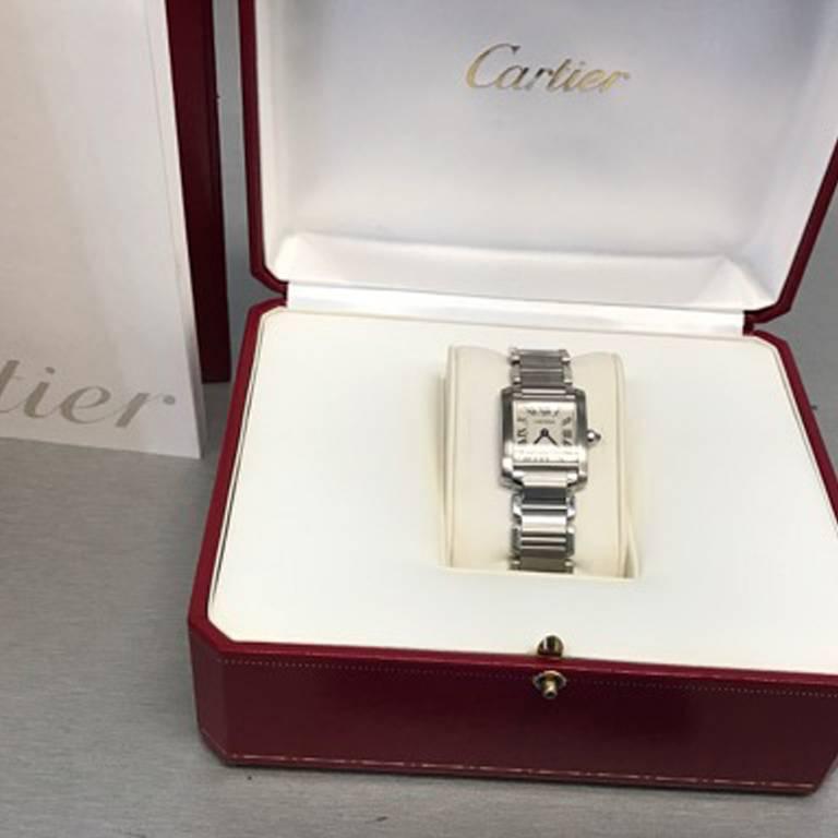 Cartier Ladies Tank Francaise Model W51008Q3. Quartz movement. Stainless Steel square style case (20x25mm). Stainless Steel Cartier bracelet with deployant clasp. Off-White Dial with black Roman numerals.  Certified pre-owned and ready to ship. 