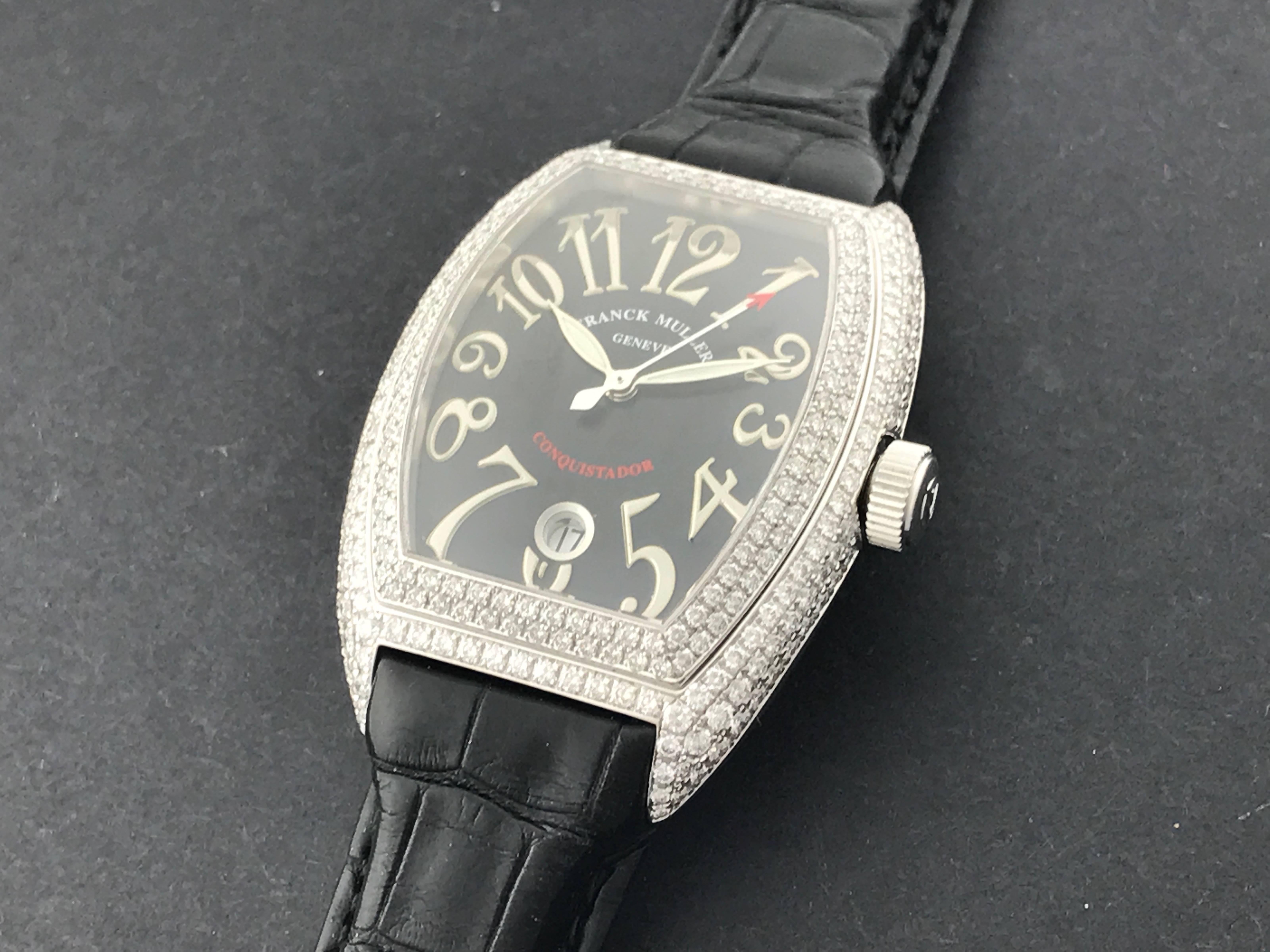 Stunning Franck Muller Conquistador Men's certified pre-owned automatic wrist watch, Model 8002 SC D. Features a black guilloche dial with arabic numerals, 18K White Gold rectangular tonneau style Full Pave Franck Muller Diamond case and black