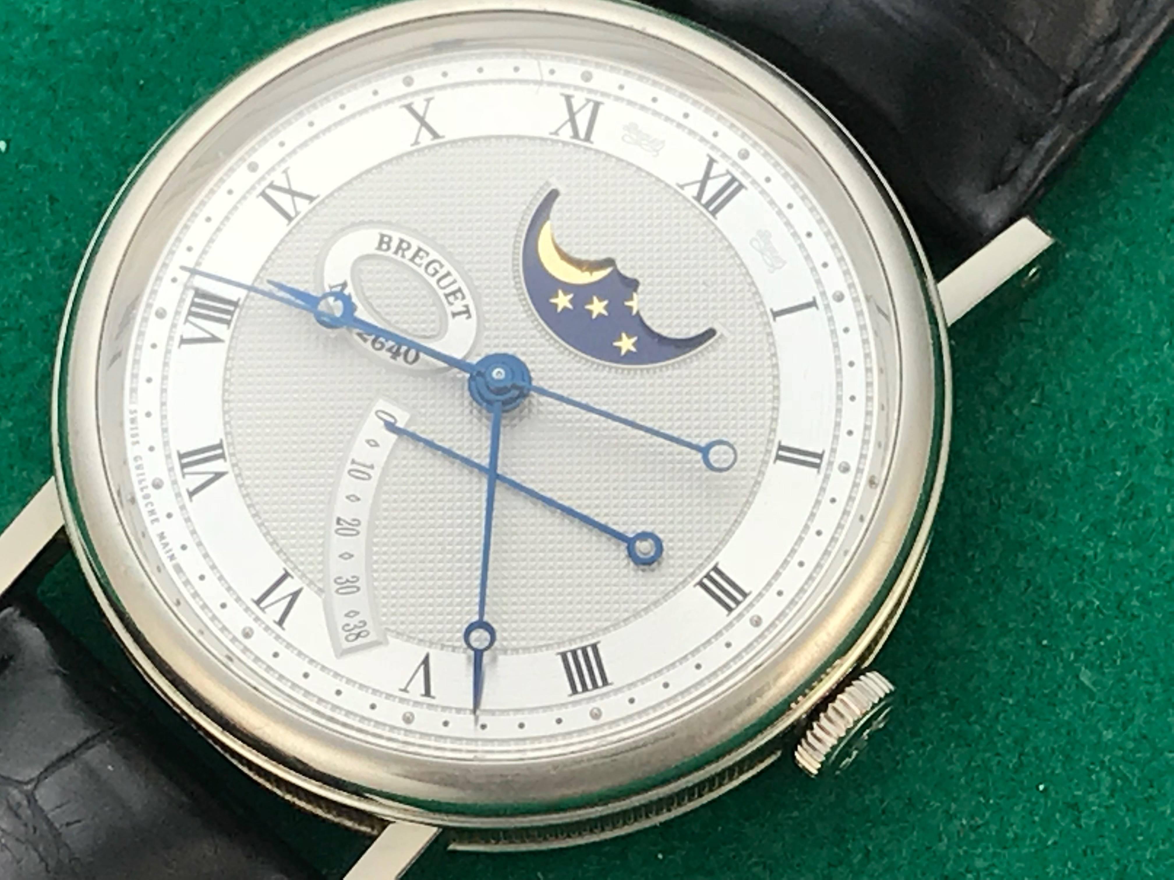 Breguet Classique Moon Phase Model 7787BB/12/9V6 pre-owned men's automatic wrist watch. Moonphase with Power Reserve Indicator and sweeping center seconds. Breguet Caliber 591 DRL Self Winding Movement and guilloche Dial with black Roman numerals.