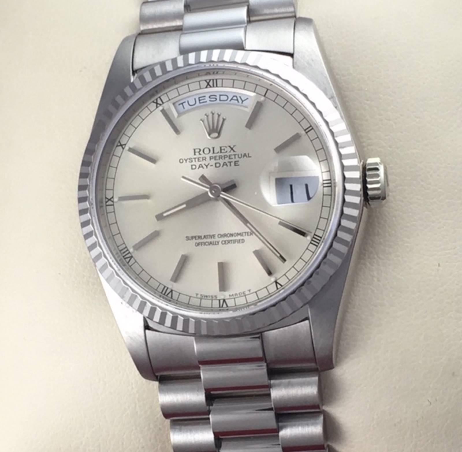 The Rolex President Day-Date Model 18239 pre-owned men's automatic wrist watch. Certified pre-owned and ready to ship.  Featuring an oyster silvered dial with polished hour markers and 18k white gold case with fluted bezel. Measures 36mm. Comes on a