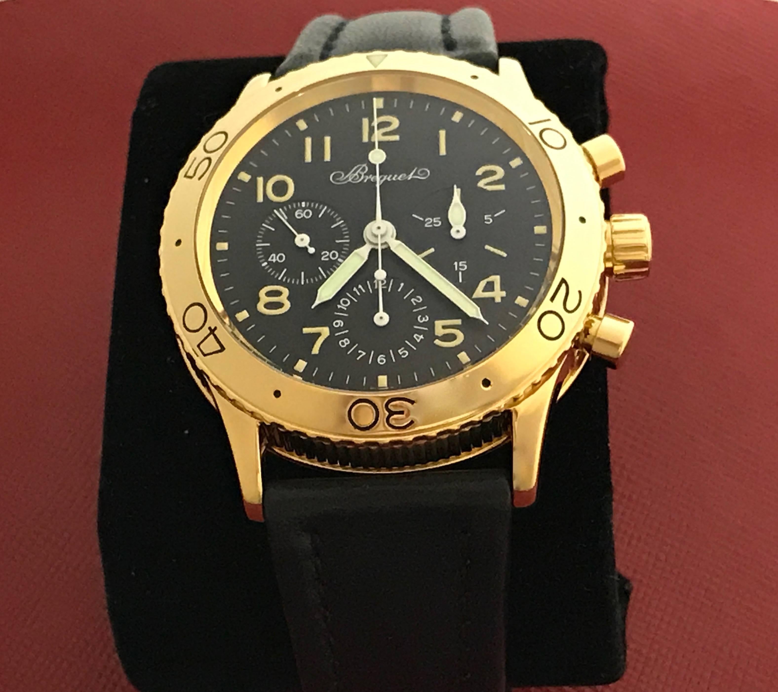 Breguet Aeronavale Type XX Chronograph Model 3800, pre-owned mens automatic wrist watch. Featuring black dial with luminous arabic numerals and 18k yellow gold case. Measures 39mm. Comes with a strap band and 18k yellow gold Breguet deployant clasp.