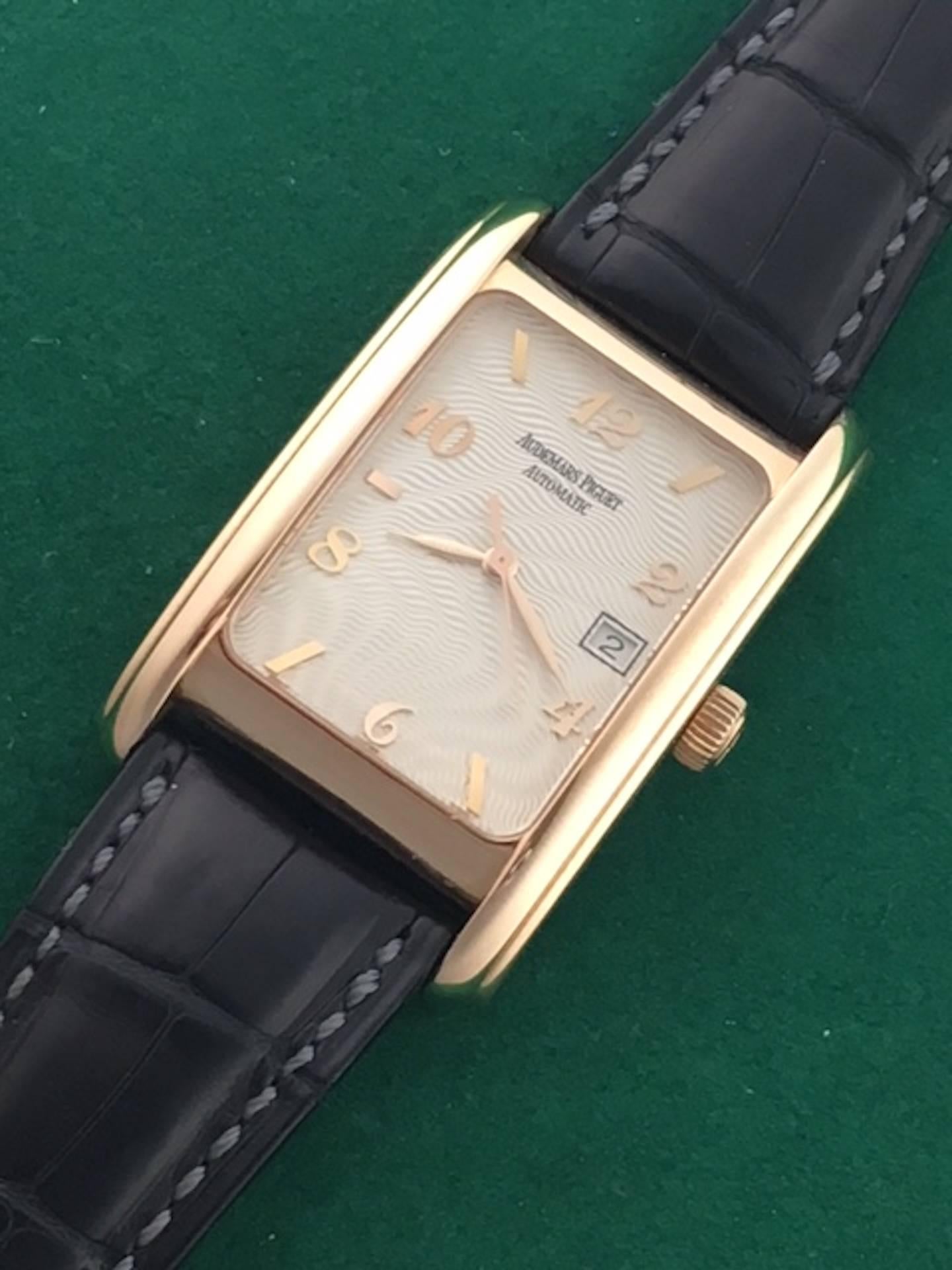 Audemars Piguet Edward Piguet Model 15121OR.OO.A002CR.01 Pre Owned Mens Automatic Winding with Date wrist watch. Silvered textured pattern Dial with rose gold hour markers and Arabic numerals, 18k Rose Gold rectangular style case (27x44mm). Strap