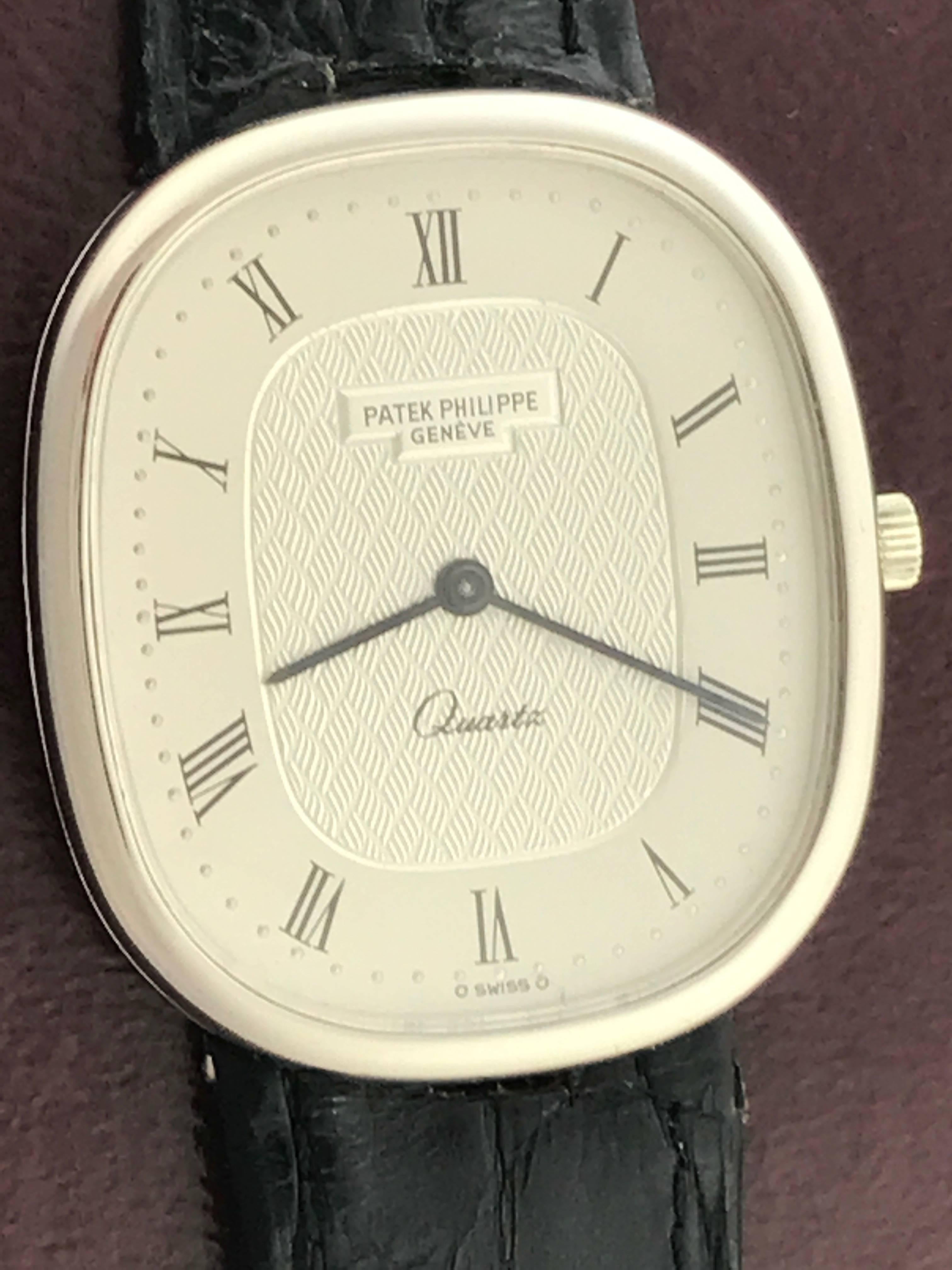 Patek Philippe Men's 3838 Wrist Watch in 18K White  Gold. This is an heirloom piece you can pass down for generations.  This timepiece features an 18K white Gold ellipse case, measuring 31x35mm in diameter.  Silvered Dial with black roman numeral