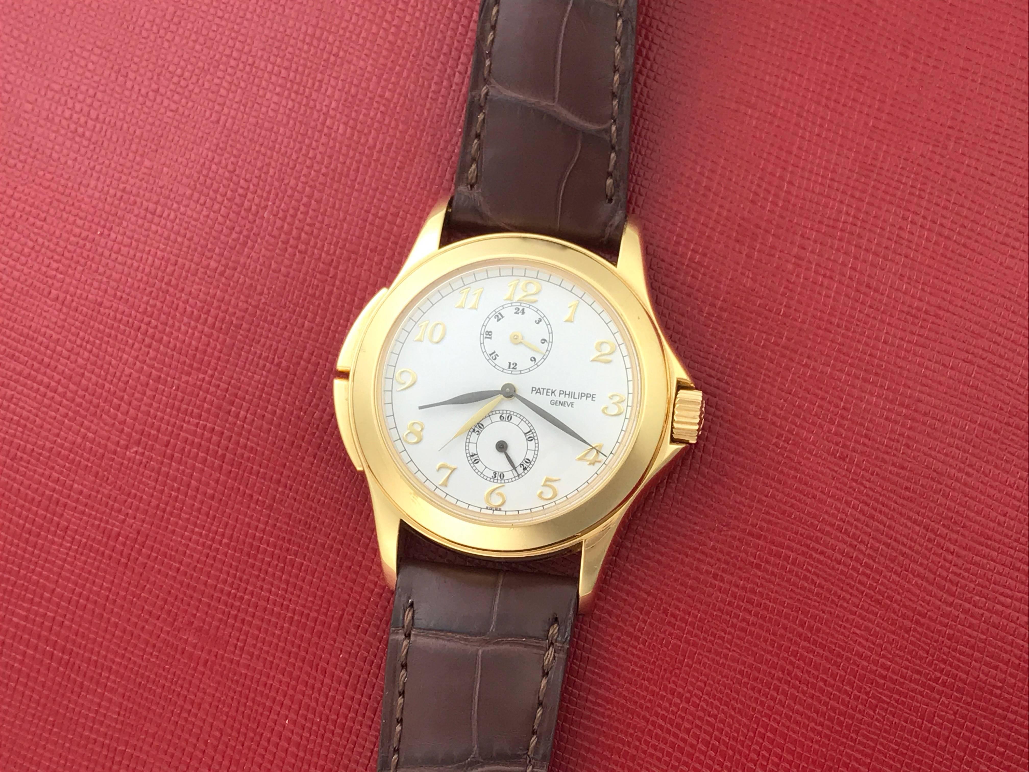 Contemporary Patek Philippe Yellow Gold Travel Time Manual Wind Wristwatch