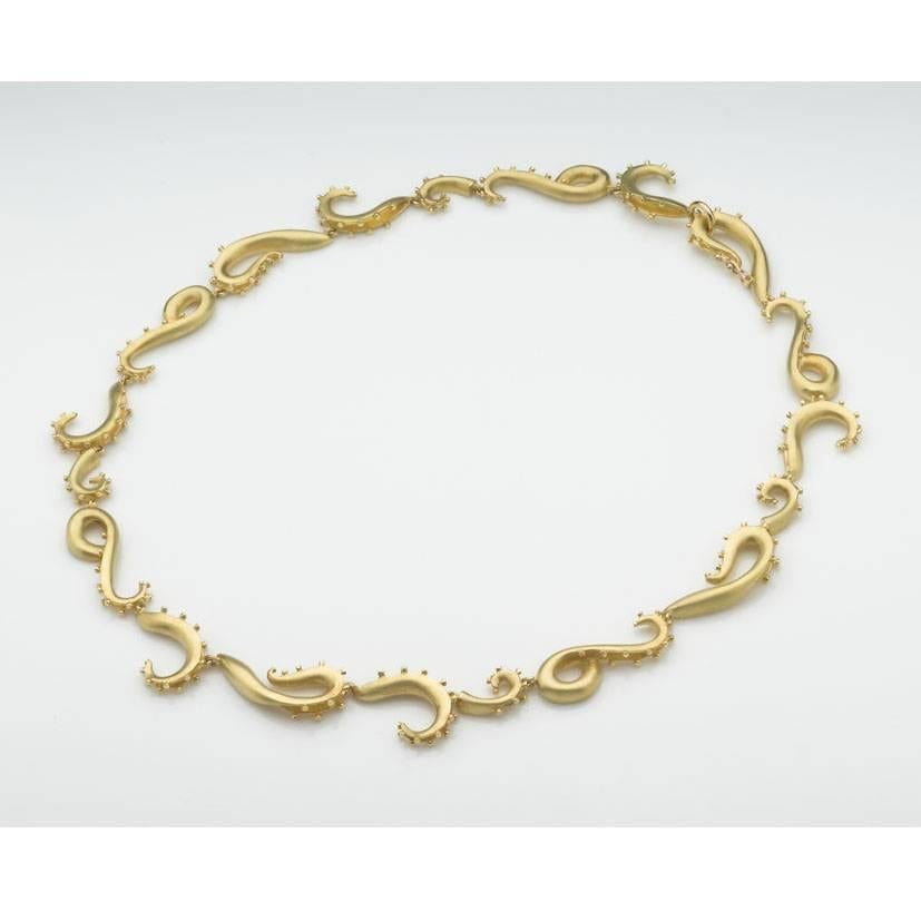 Striking and substantial 18ct yellow gold Tentacle necklace. The sinuous tentacles are edged with little gold beads which twinkle catching the light. the necklace has a satin finish, and the fastening comprises a hook and safety clip.