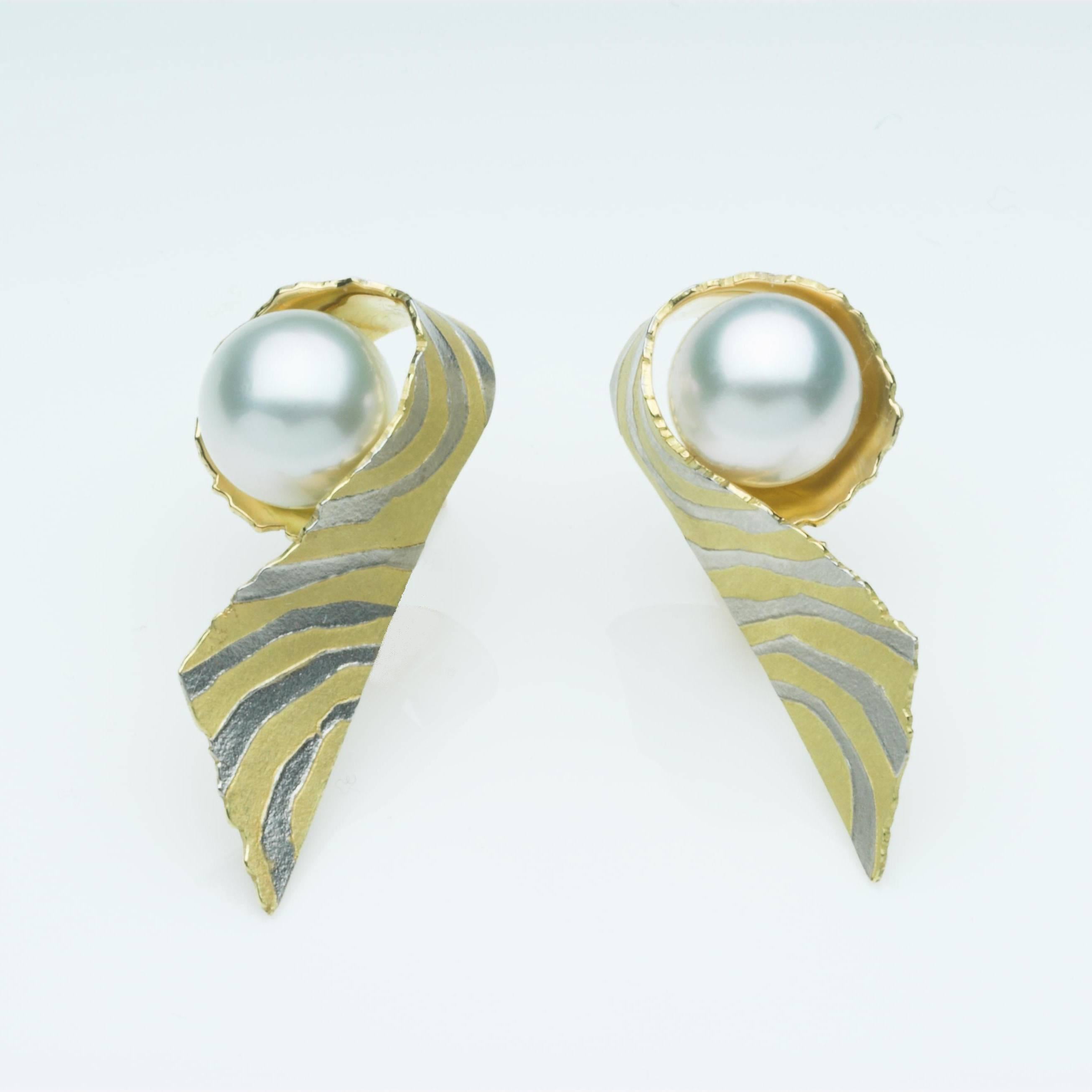 18ct gold Contours earrings with a fused platinum inlay, set with south sea pearls, the pale grey of the south sea pearl are set off beautifully by the platinum. The fittings are posts and clips.