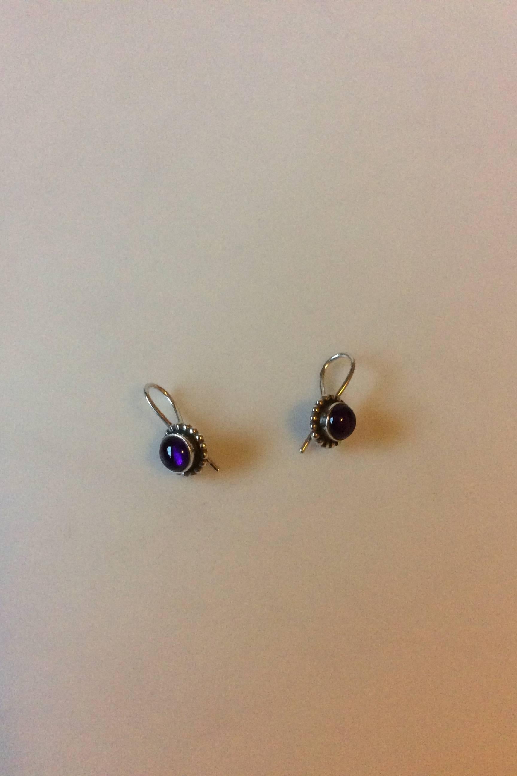 Georg Jensen Sterling Silver Earrings, Moonlight Blossom No 9 with purple stone. Measures 2 cm / 3/4 in. Weighs under 0.20 oz