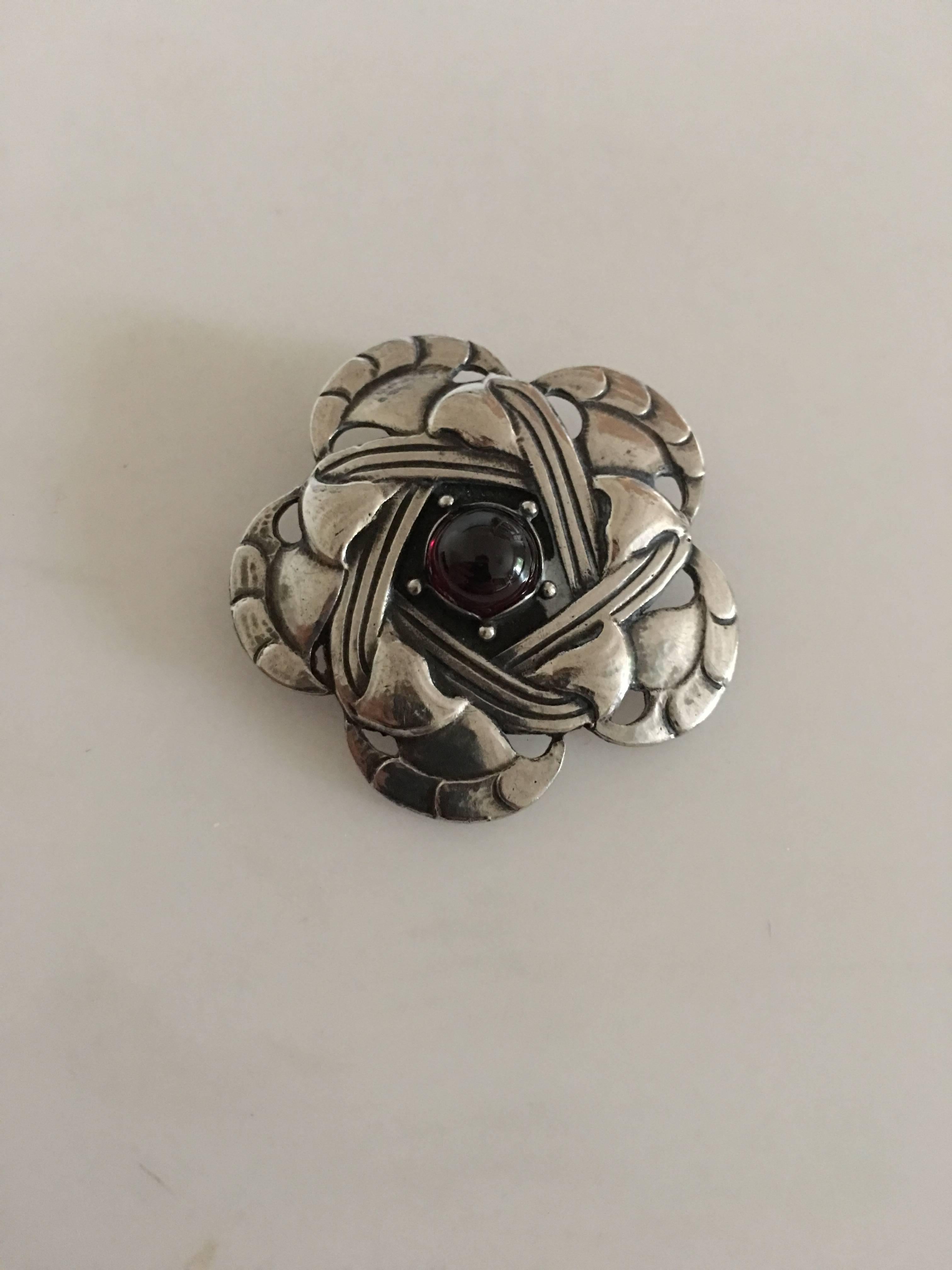 Early Georg Jensen Silver Brooch with Red Carnelian. Measures 4 cm diameter, weighs 12 grams (0.40 oz). Manufactured 1909-1914. In beautiful condition.
