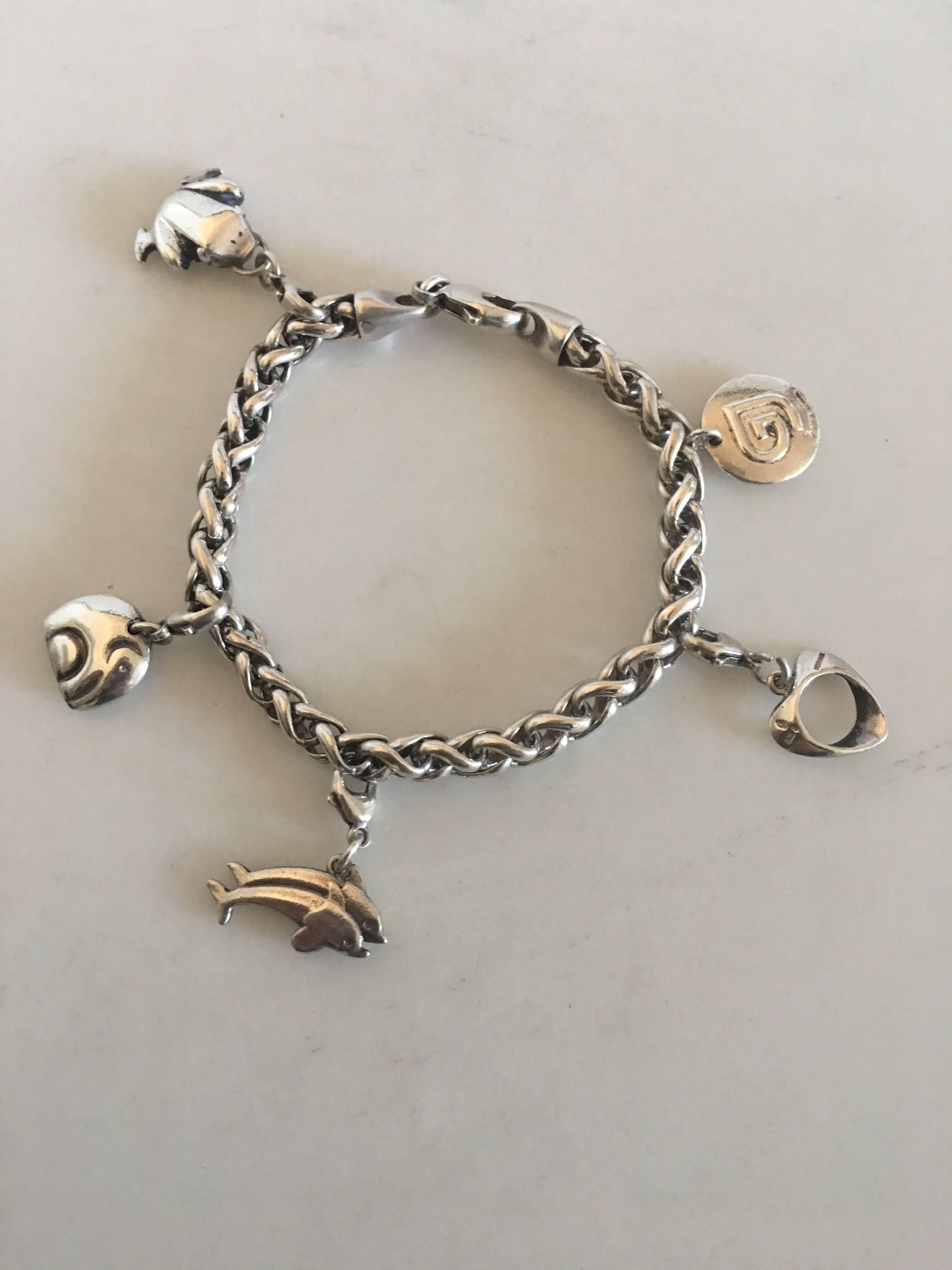 Georg Jensen Sterling Silver Charm Bracelet. With charms: Frog, Elephant, Dolphin, a Henning Koppel Heart and a Georg Jensen Charm Sign. Measures 20.5 cm L (8 5/64