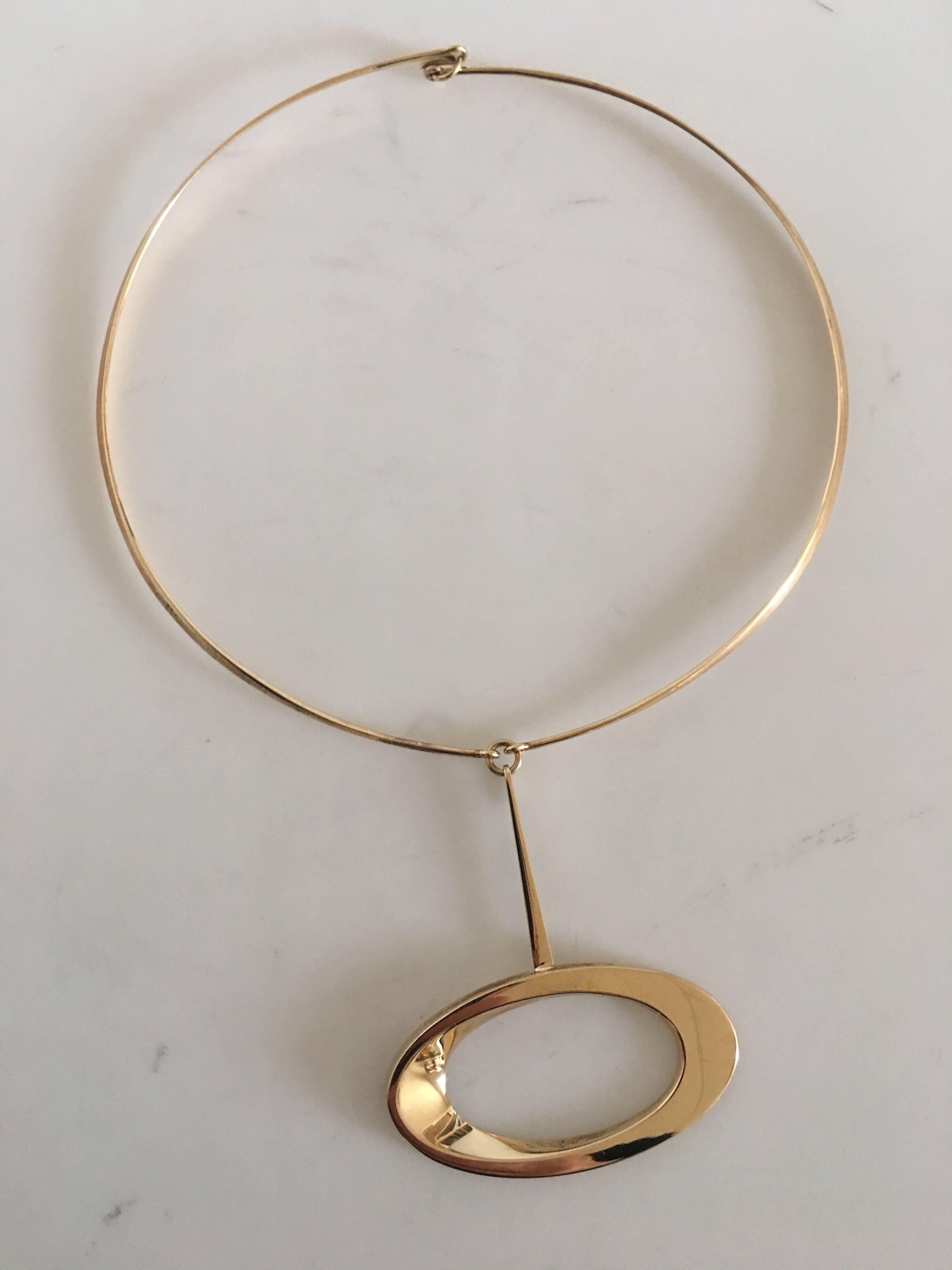 Hans Hansen 14K Gold Pendant No. 103 in 14K Gold Chain (Not by Hans Hansen). Diameter of the neckring measures 12 cm. Oval diameter of the pendant measures 5.5 cm. Weighs 23 grams.
