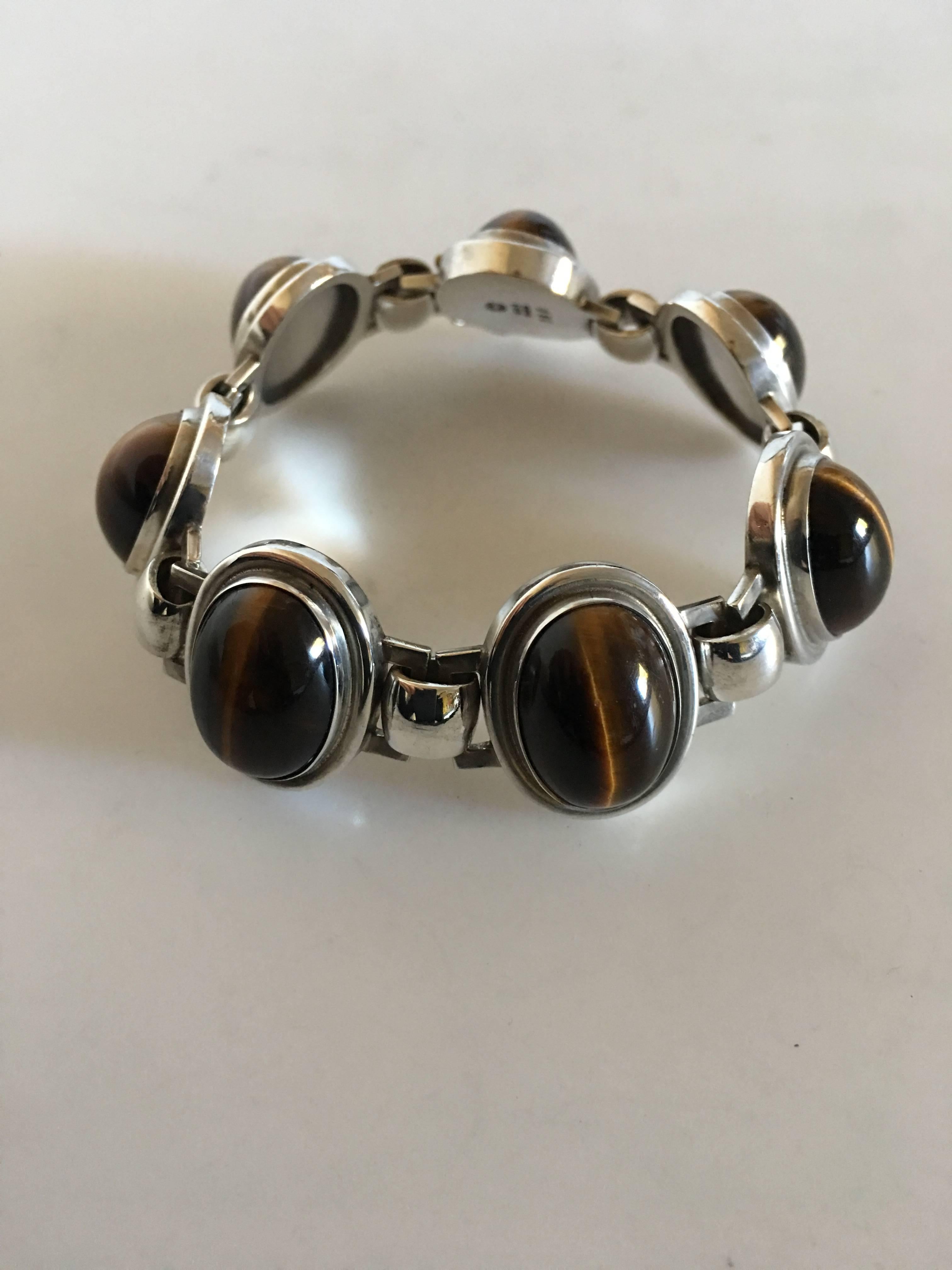 Georg Jensen Sterling Silver Bracelet No. 52A with Tiger's Eye Stones. 19 cm L. 2.3 cm Wide. Weighs 68 grams. From after 1945.