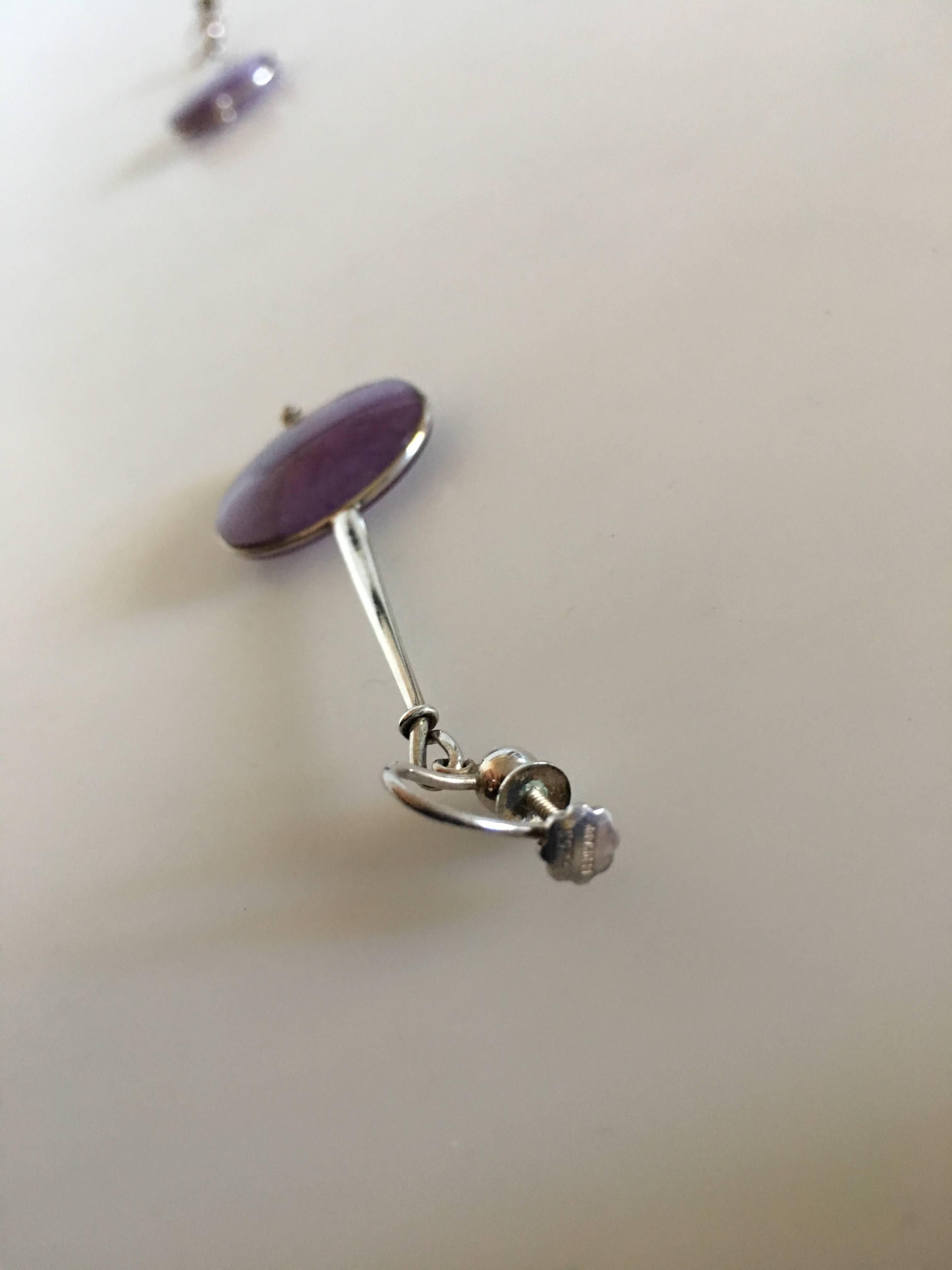 Georg Jensen Sterling Silver Torun Earrings No. 245 with Amethyst. Measures 6 cm L. 2.5 cm dia. Weighs a combined 12 grams.