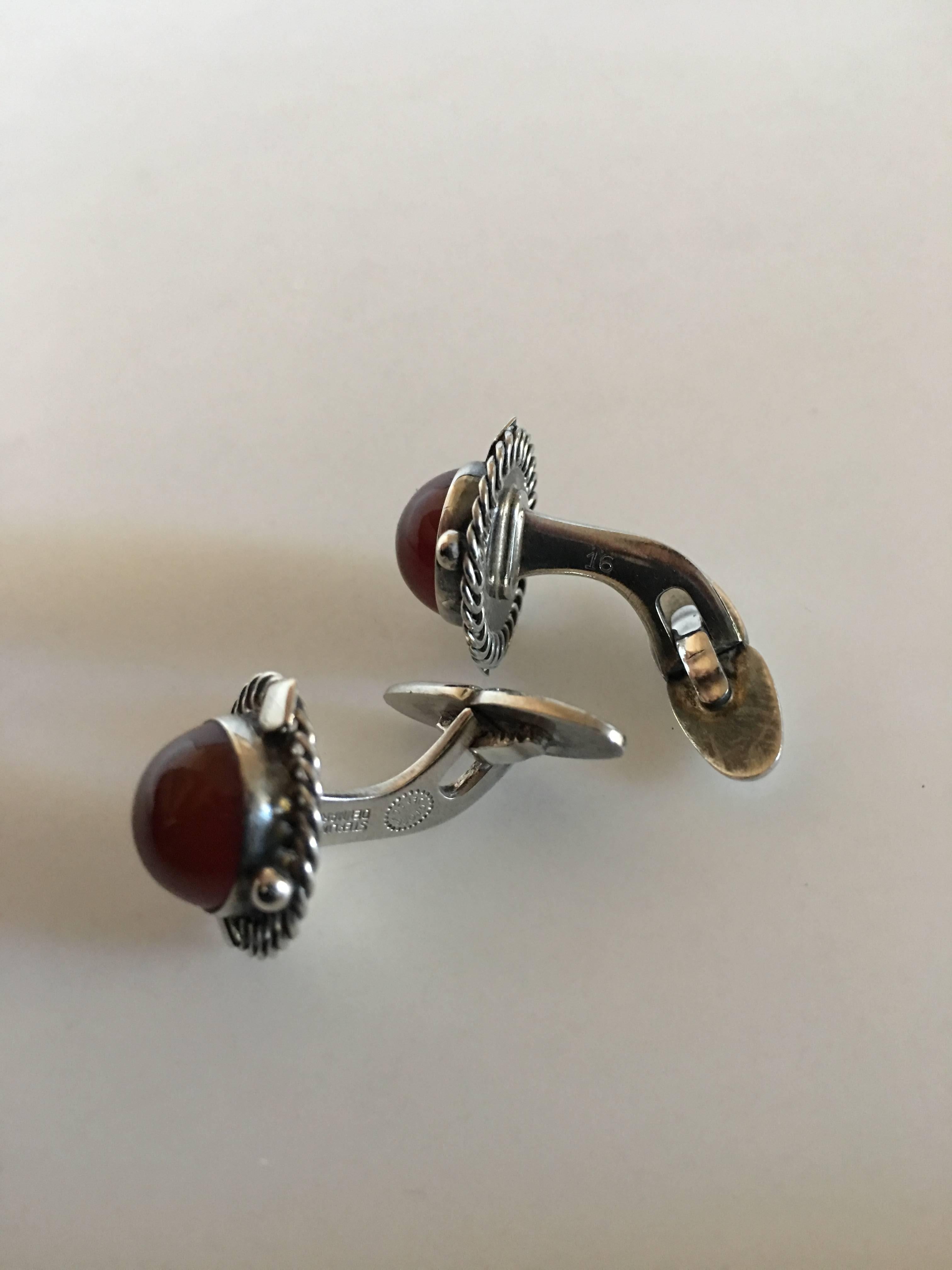 Georg Jensen Sterling Silver Cufflinks No. 16 with Amber. Measures 1.8 cm diameter. Combined weight of 12 grams. From after 1945.