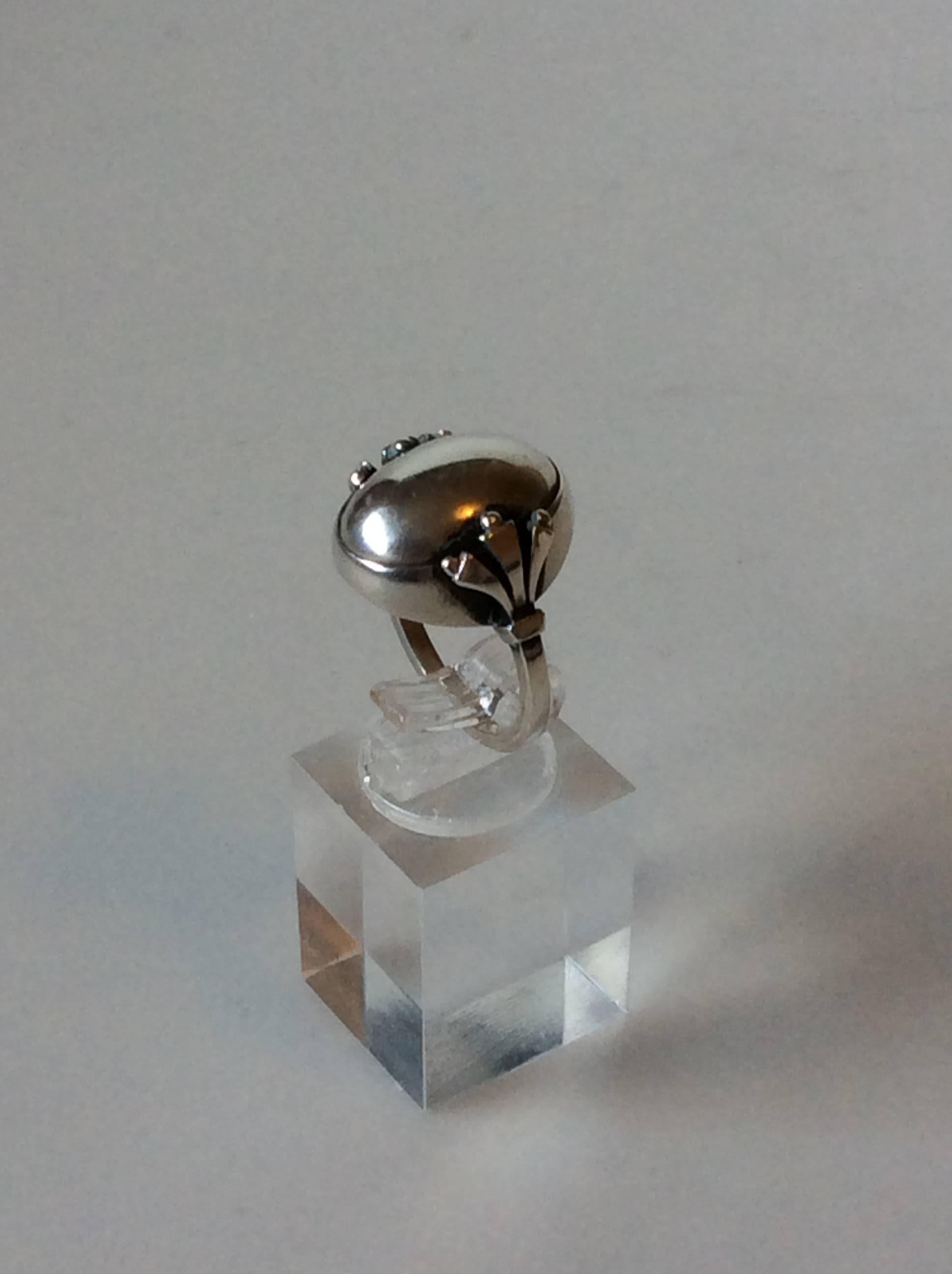 Georg Jensen Sterling Silver Ring with Silver Stone No. 51.

Ring size 54 or US 6 3/4.

Weight is: 8,76 grams / 0.310 oz.

Post 1945 marks