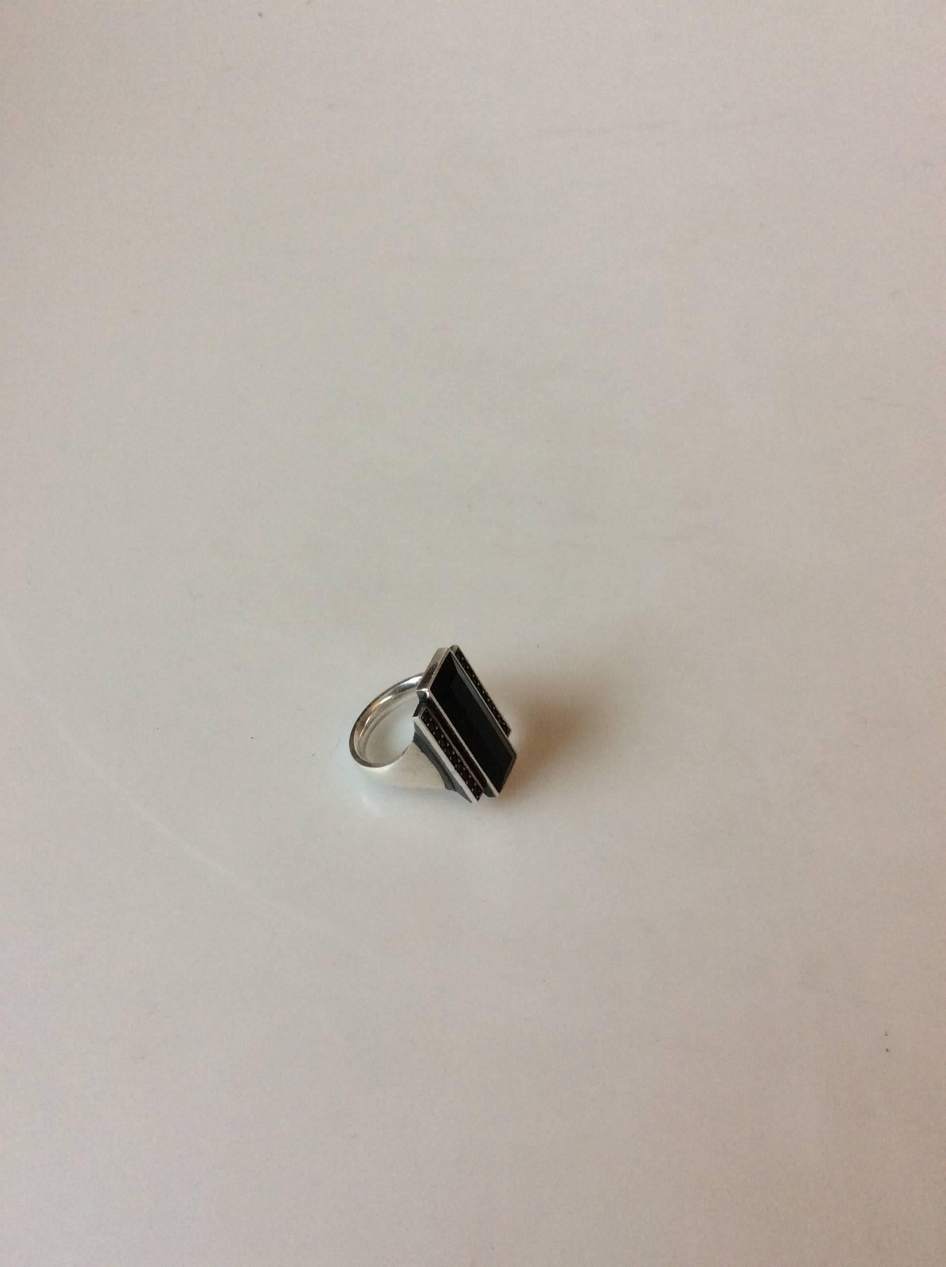 Georg Jensen. Nocturne ring 571A in sterling silver with black agate and treated pavement-black diamonds. Str 55. Design Regitze Overgaard.

Weight is 15,73 grams / .555 oz.