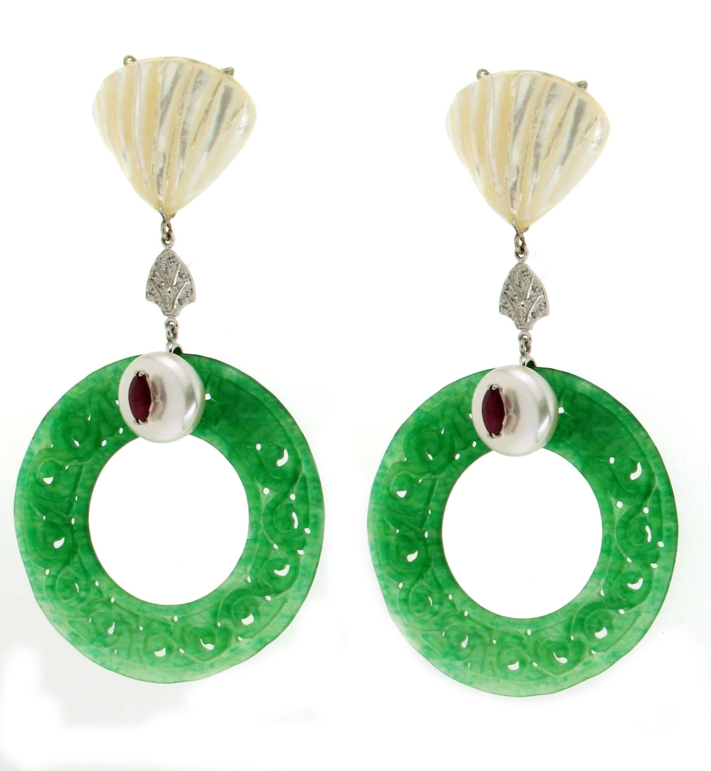 Jadeite jade and nacre white gold 18 carat little diamonds and shuttles rubies drop earrings

Earrings weight 25.30 grams 