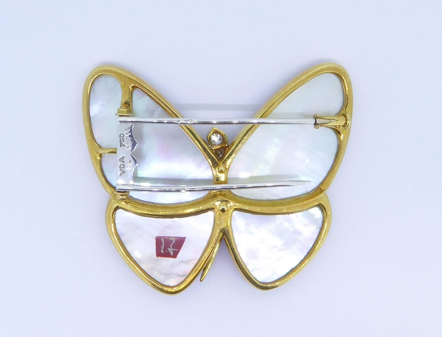 A Van Cleef & Arpels and Junichi Hakose Gold Diamond And Lacquer Butterfly Brooch. Mounted in 18ct yellow gold with 18ct white gold pin. The center of the butterfly has 9 graduated round brilliant-cut diamonds with an approximate total weight of