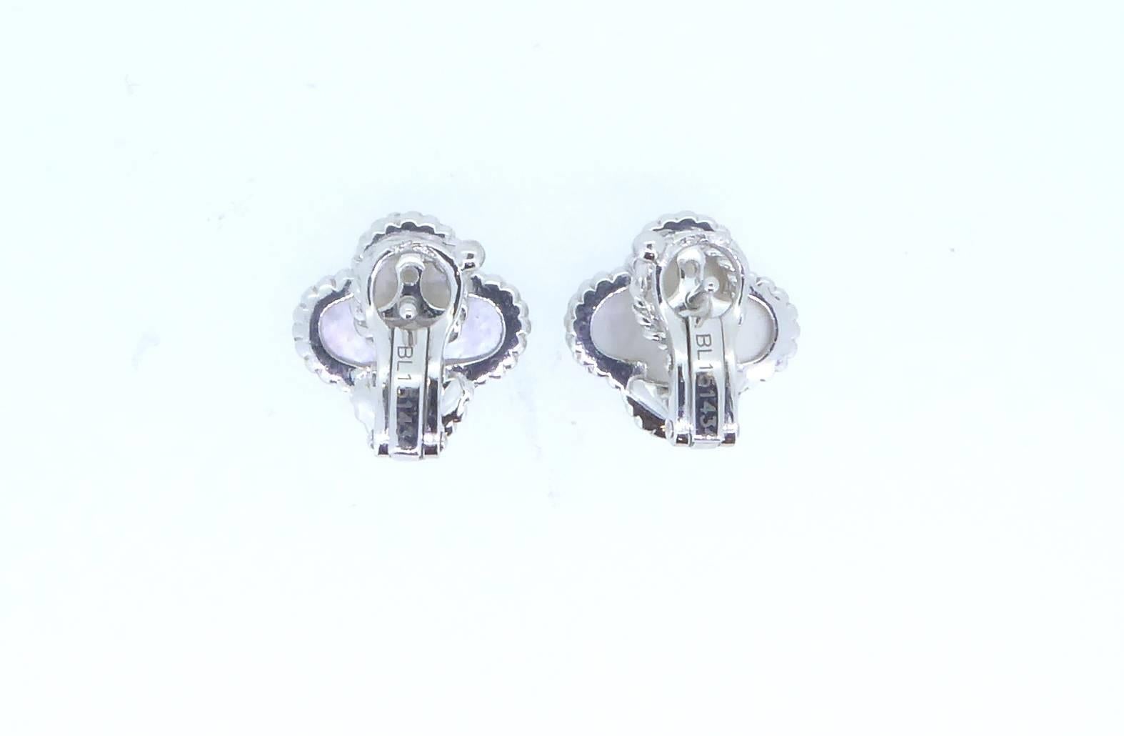 A pair of Van Cleef and Arpels Alhambra mother-of-pearl and 18ct white gold ear clips. Each ear clip with singular mother-of-pearl motif. Set in 18ct white gold. Each clip marked "VCA" "750" and "BL 151434". With French