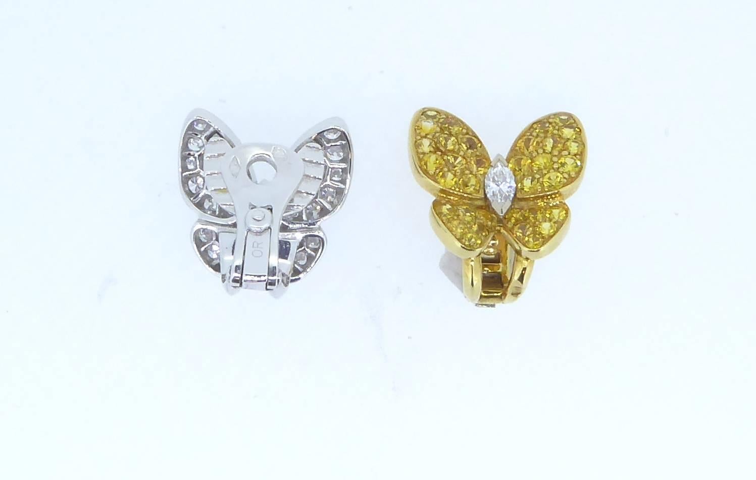 A pair of Van Cleef & Arpels Yellow Sapphire Diamond and Gold Butterfly Earrings. One ear clip with white diamonds set in 18ct white gold and a marquise diamond body. The other ear clip with yellow sapphires set in 18ct yellow gold and a marquise