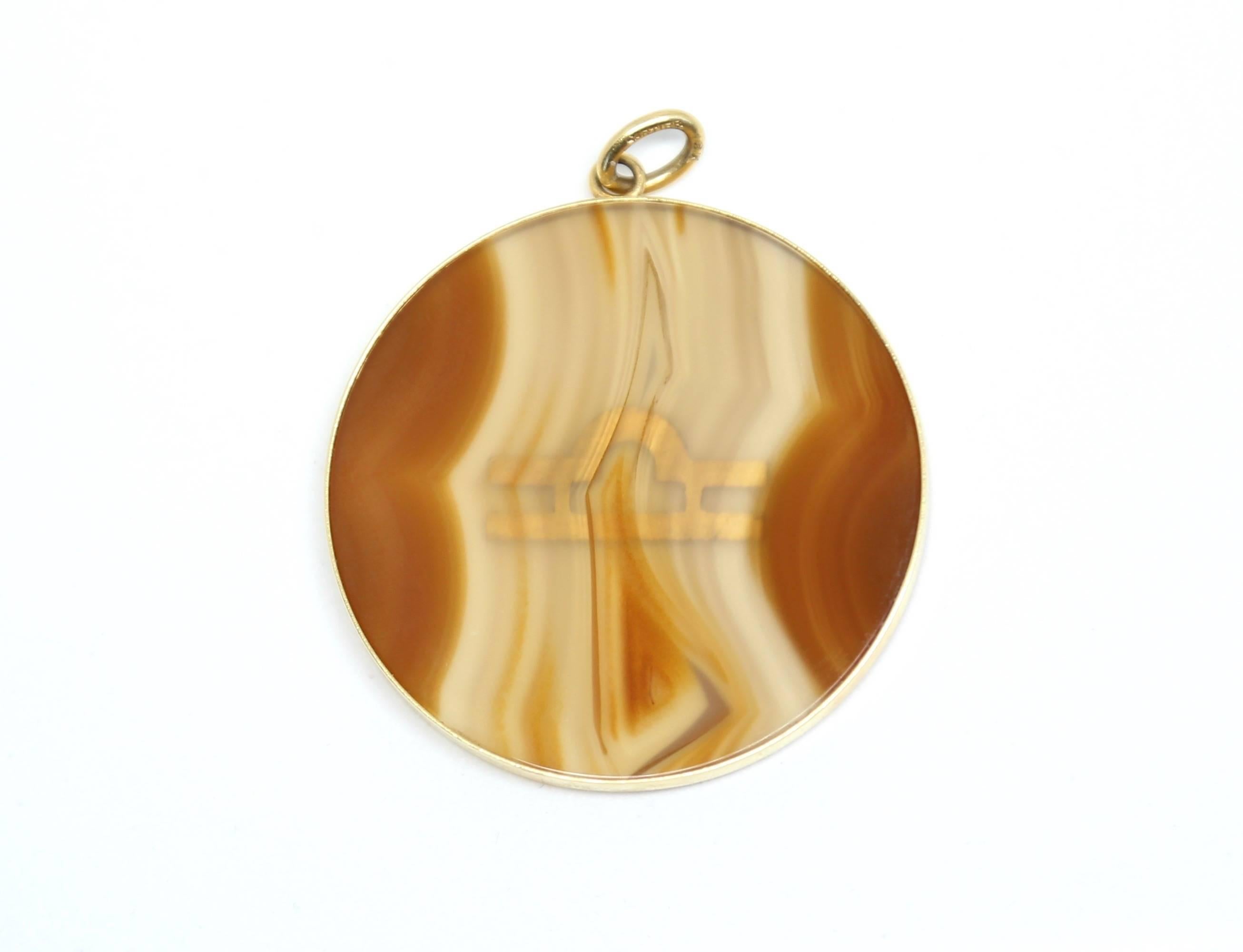 Unusual agate and 18k gold 'Libra' astrological pendant designed by Cartier dating to the 1970's. Pendant measures approximately 5 cm with bail. Agate measures approximately 4.1275 cm. Thickness is approximately 0.3175 cm. Marked 'Cartier' and