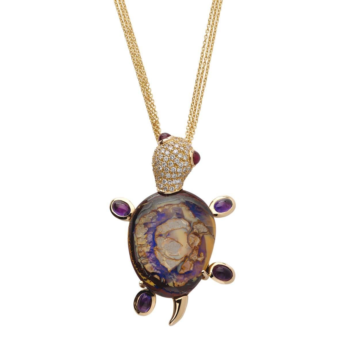 This cute little turtle is crafted in 19.2K yellow gold and set with a boulder opal, white diamonds, rubies and amethysts it is a unique piece because of the shape and colors of the central stone. 
It was conceived has a brooch but can be worn as a