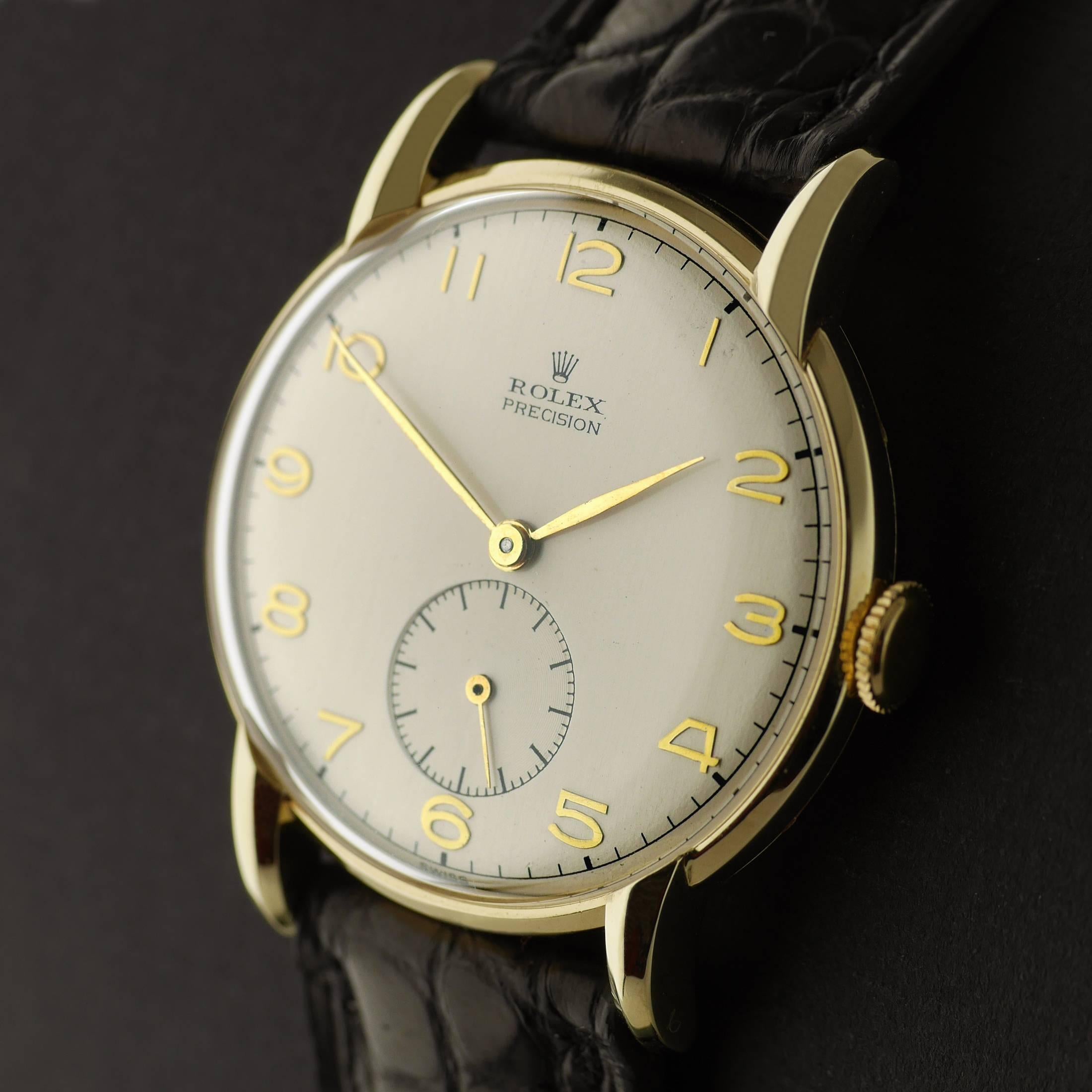 Ein Vintage Rolex Precision Armbanduhr in c1945
Modell 4635

Snap zurück 14 Karat Goldgehäuse gemacht. Rolex 17-Rubies Präzisionsankerhemmung mit Superbalance. Versilbertes Zifferblatt mit erhabenen arabischen Ziffern aus Gold:: mit Hilfszifferblatt