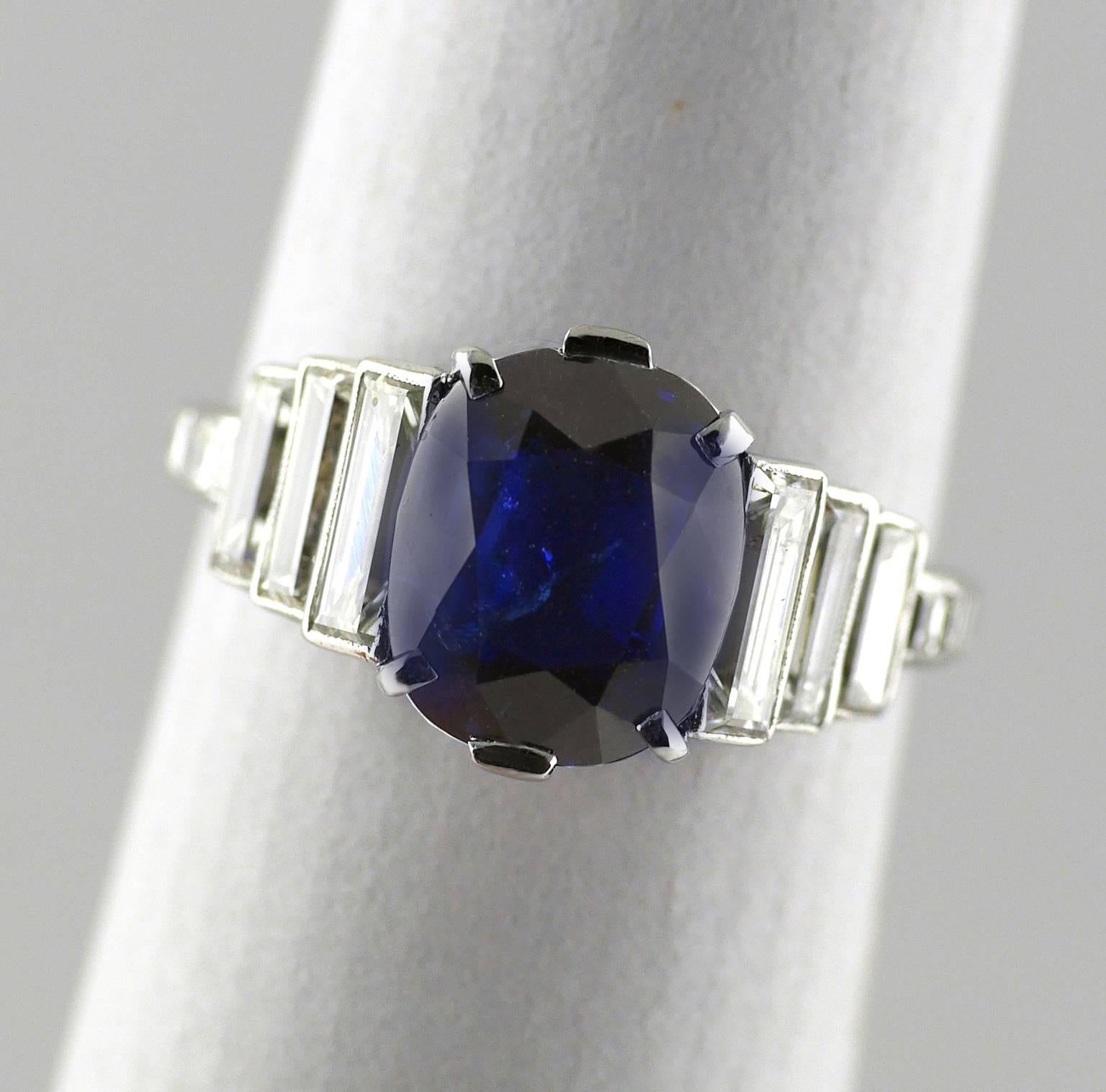 Natural colour, untreated, 2.99 carat sapphire and diamond Art Deco Platinum ring circa 1930.

With three stepped baguette diamonds on each shoulder F/G/H, Vs1, total weight approx 1.0ct. Gemmological Certification Services Certificate.

Ring