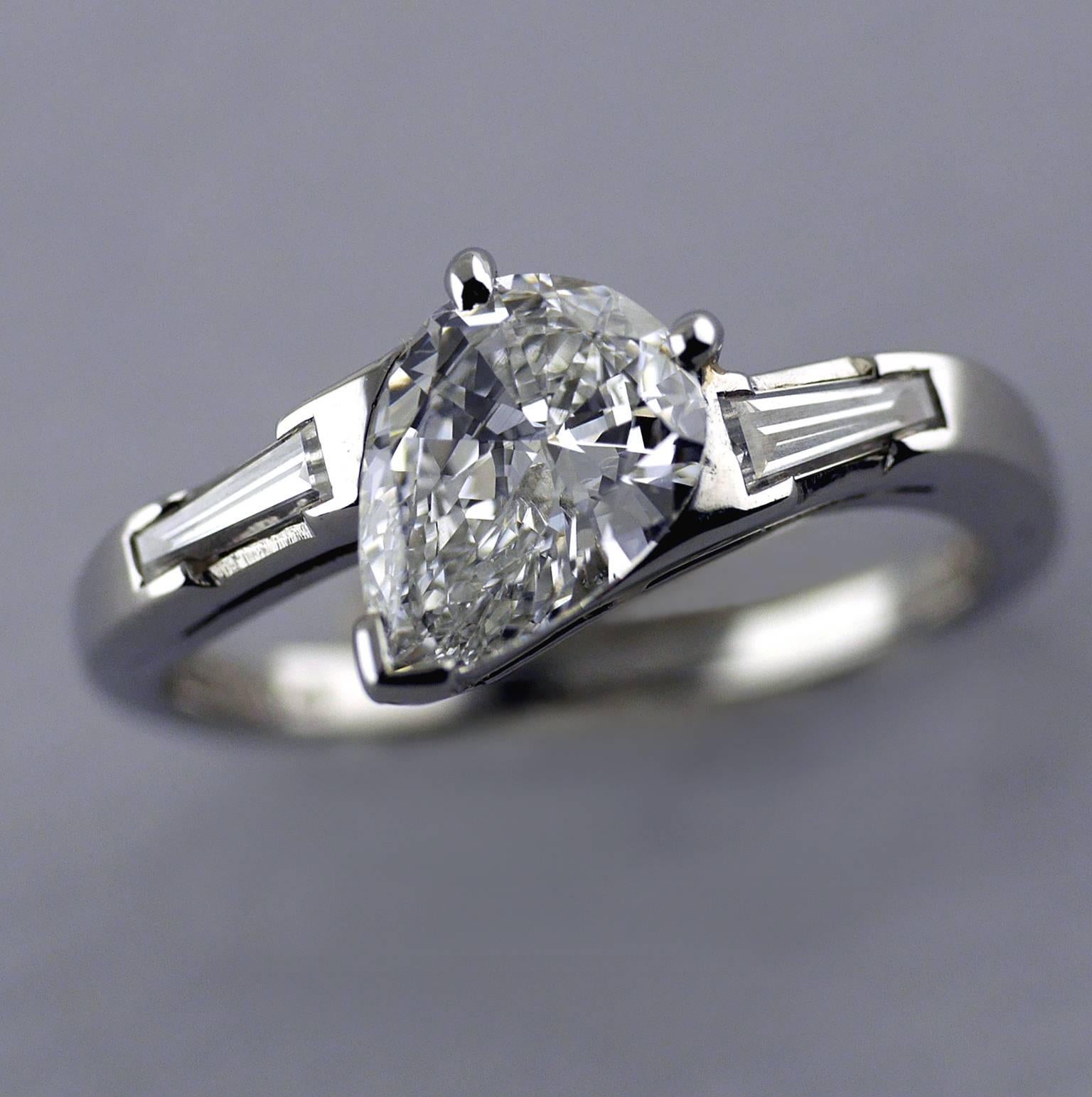 Platinum Pear Shape Diamond ring circa 1960.

1.01ct Pear shape diamond, D, Vvs2, set in a platinum shank. With two tapered baguette diamonds on the shoulders of approx 0.30ct F/G, Vs1 (total weight). International Gemmological Report