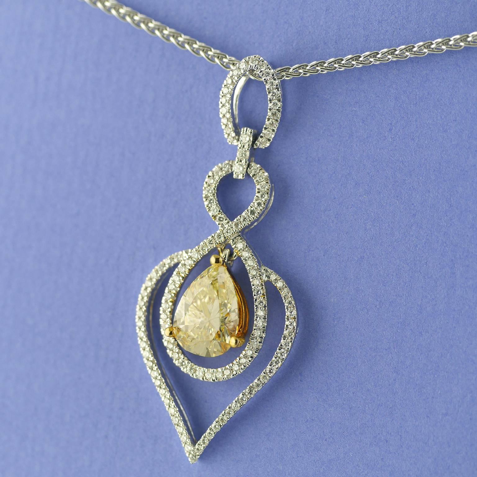 Light Fancy Yellow, natural, untreated, Diamond Pendant circa 1970 on an 18 carat white gold chain.

Articulated, tremblant, central pear shape light fancy yellow diamond drop, 2.03 carats, VVS2 (Certificated) mounted in 18ct yellow gold. Surrounded