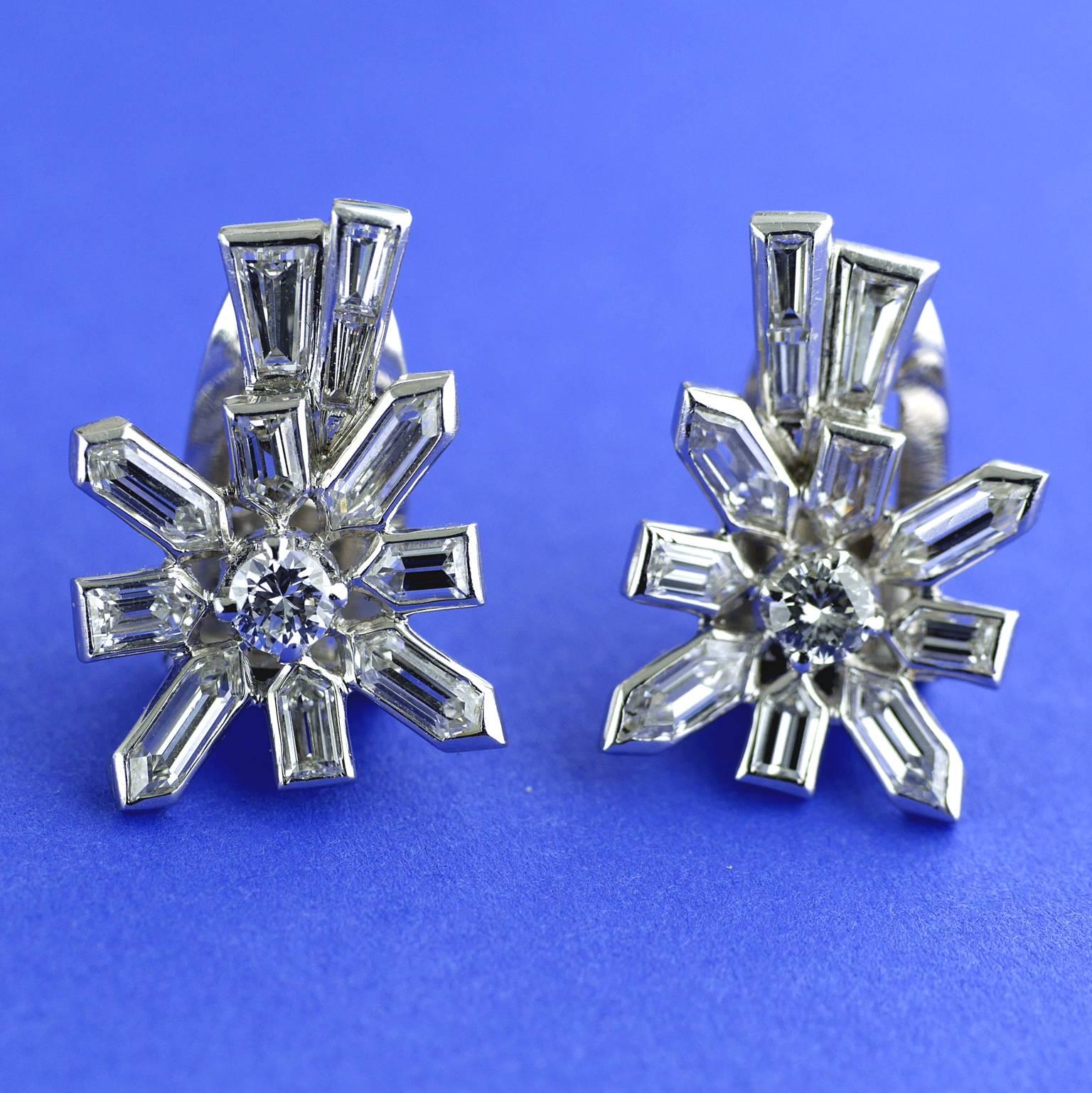 18ct white gold and diamond earrings made circa 1958.

This design was inspired by the space race of the 1950’s, when the first  man made satellite, the Sputnik, was  launched  into orbit. 

These  starburst shaped earrings are in 18ct white gold