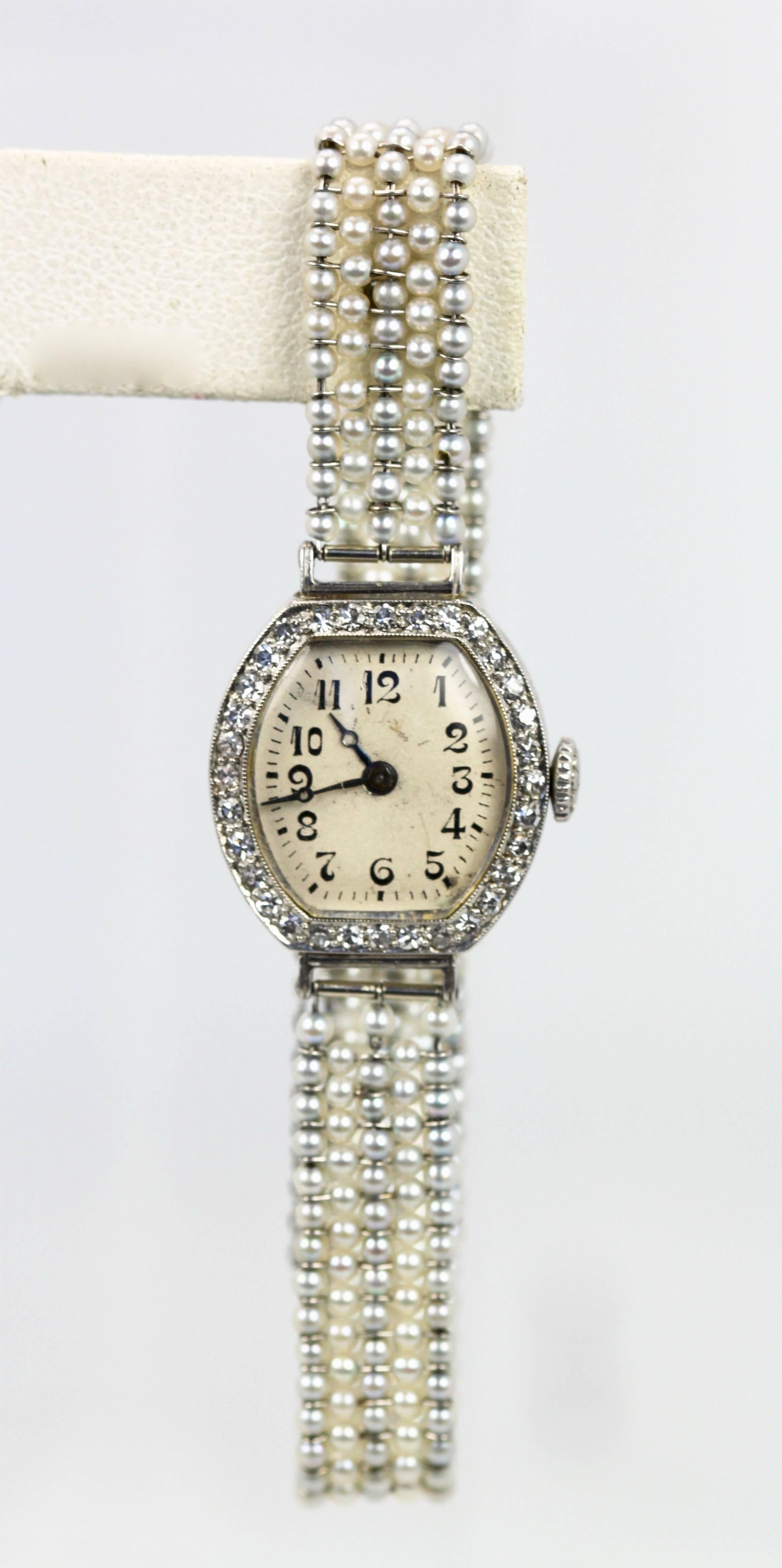 This watch was made during the 1920-30's and is made up of Multi-colored seed pearls as the strap and a Diamond surround.  The seed pearls are natural multi colored and there are 5 rows of pearls.  The Diamond surround consists of 32 round cut