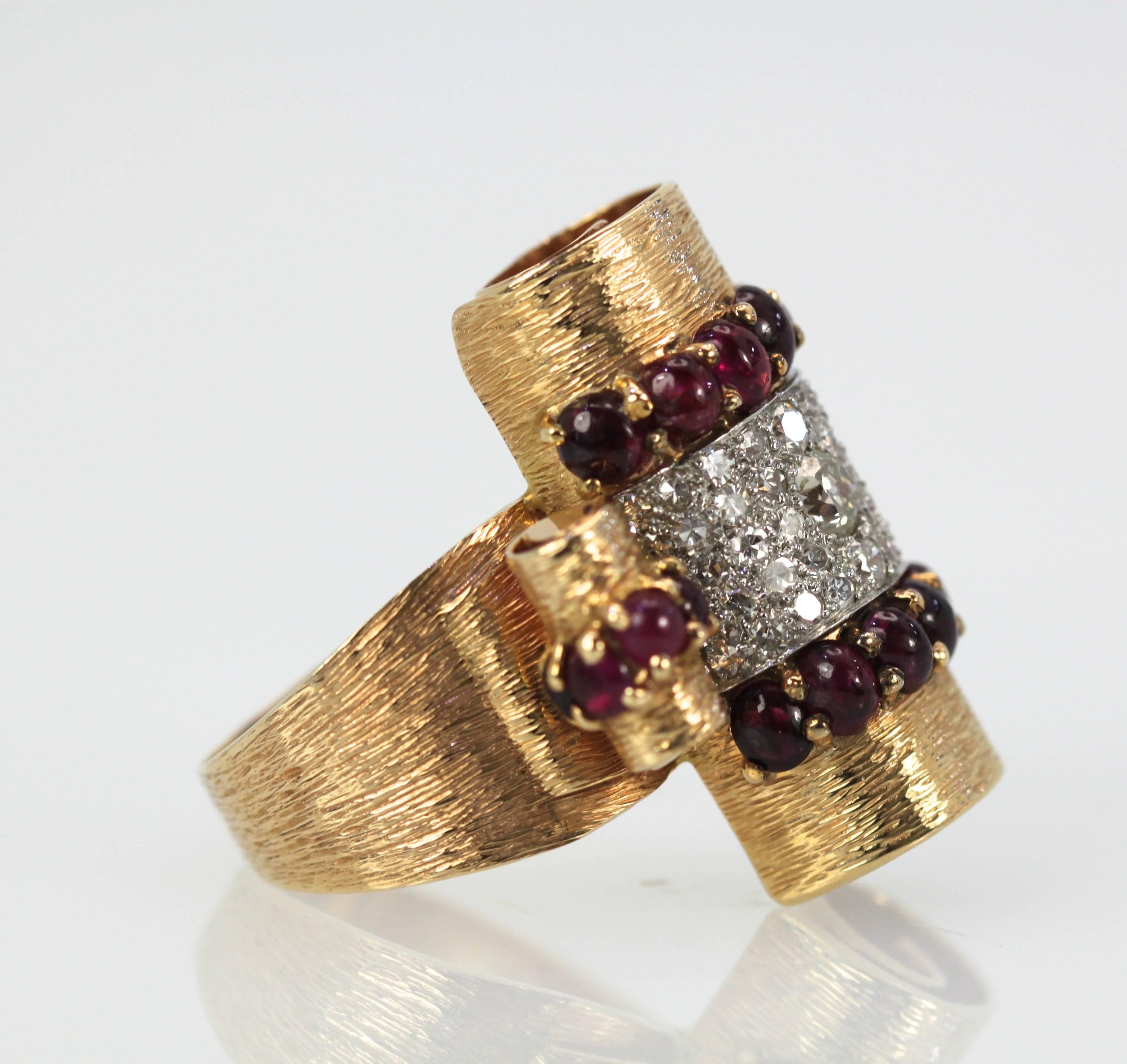 Ladies 14K Yellow Gold and Platinum Diamond Ruby ring is just awesome. This large statement ring is set with rubies garnets and Diamonds in a high roll shaped Ring. The rubies are cut into cabochons with a cherry red color and estimated carat weight