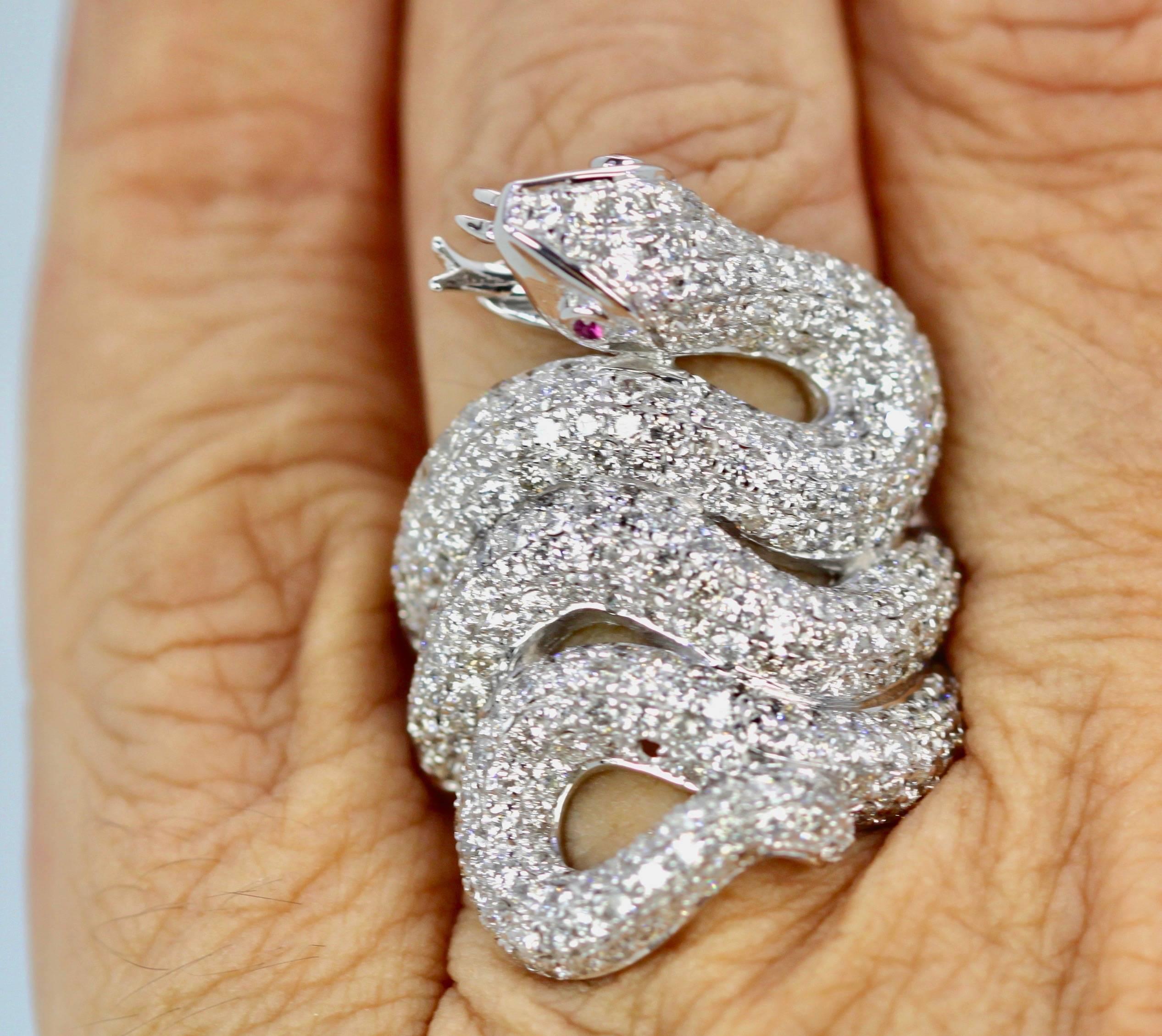 This Snake Ring is covered in Diamonds and is one of my favorites.  As you can see from the photo's this ring is large and covers my finger and it is dramatic.  For Snake lovers this is the dream snake ring, and all in Diamonds.
This piece is new
