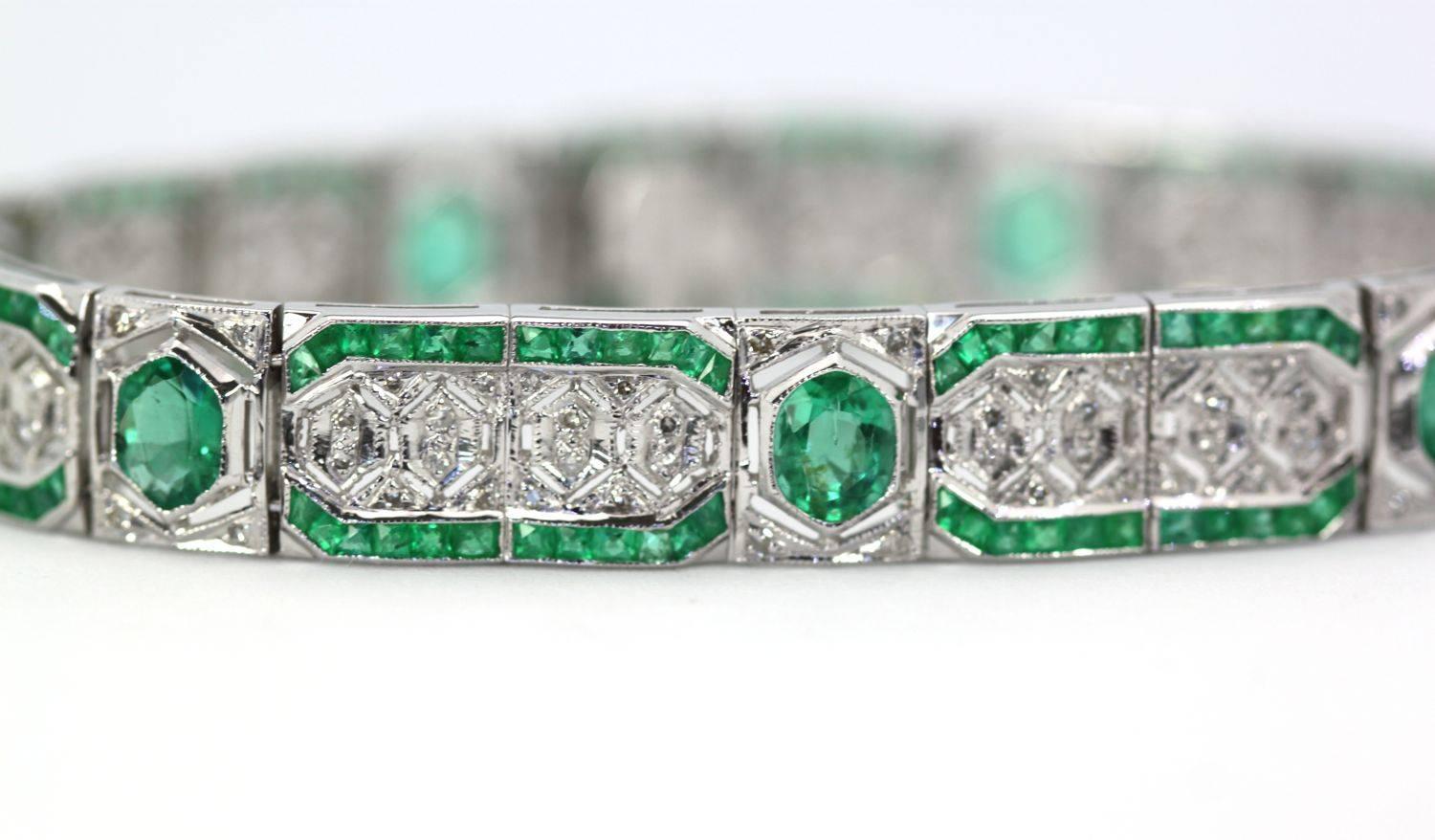 This bracelet reflects the Deco era but it is not Deco as this piece is done in 14K white gold.  The bracelet is set with 7 oval Emeralds, 168 baguette Emeralds and 112 single cut Diamonds.  The color range for the Emeralds is light Green with an