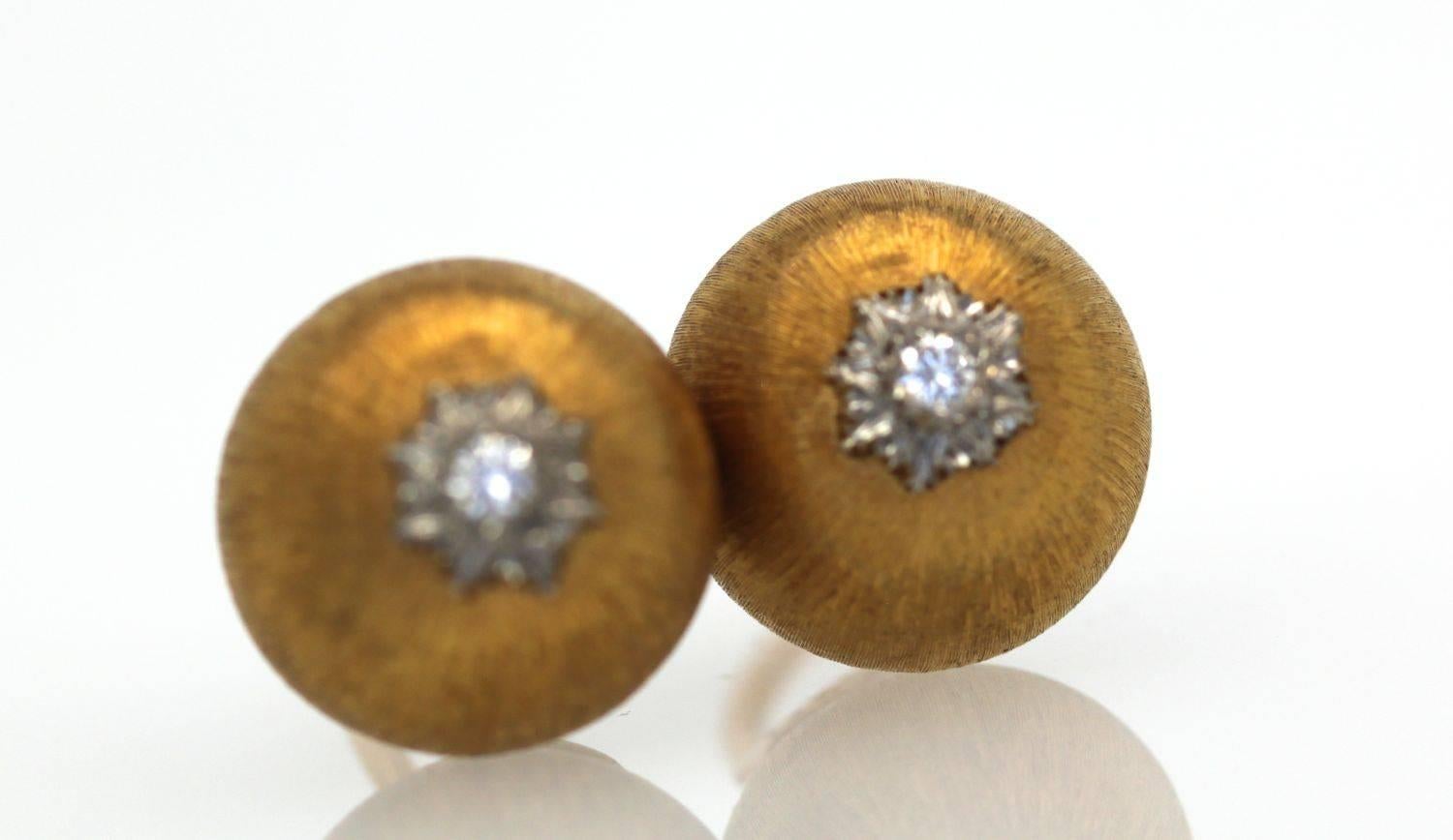 These lovely earrings are classic Buccellati.  They are 18K Yellow Gold round button bombe each set with a platinum center and a diamond set in the middle. Signed Italy, 18k and Gianmarie Buccellati




