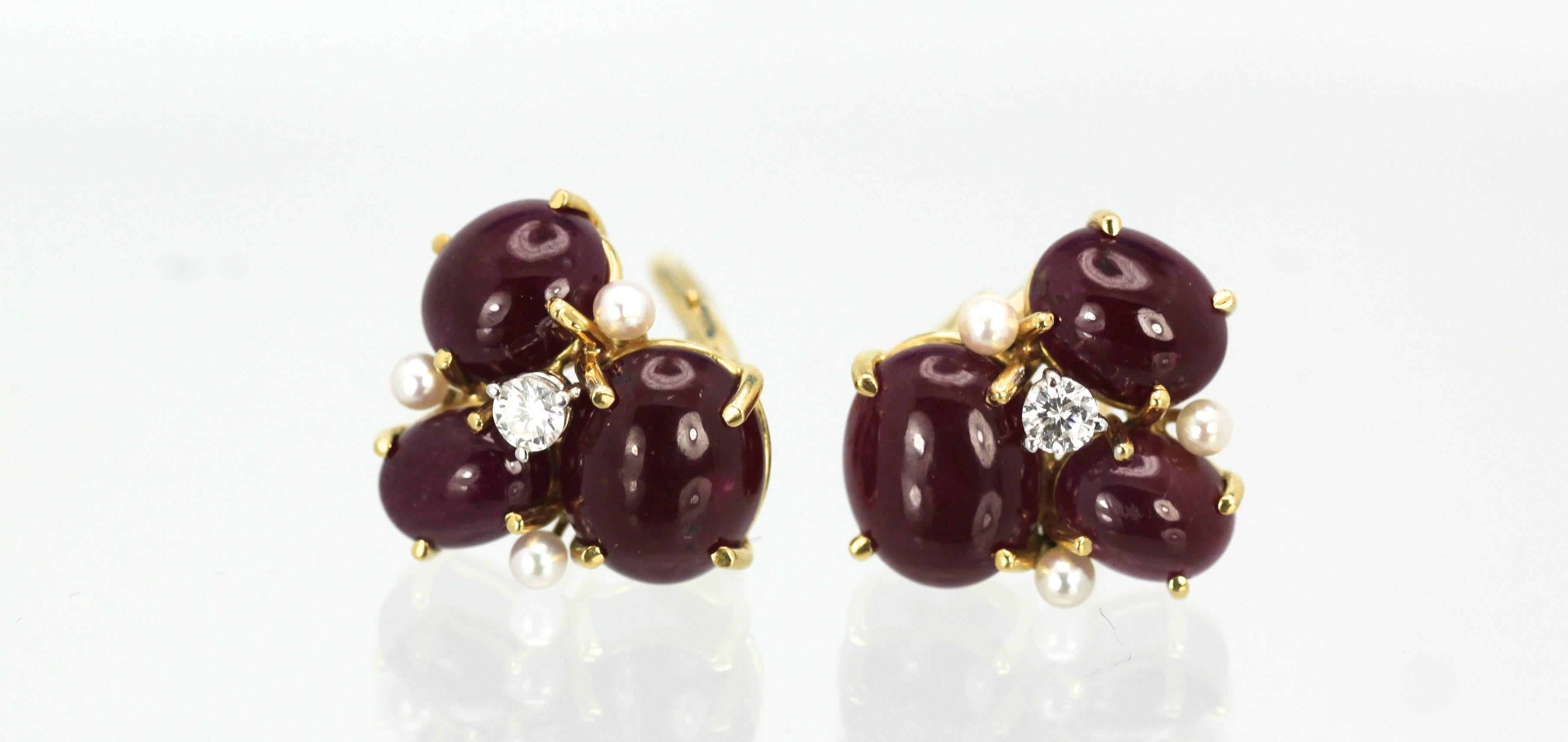 Gorgeous Seaman Schepps iconic cluster earrings in ruby cabochons. These rubies are in excellent condition and weigh approx. 6.00 carats total for each earring. They are studded with (3) seed pearls and (1) 0.10 carat diamond on each earring. There