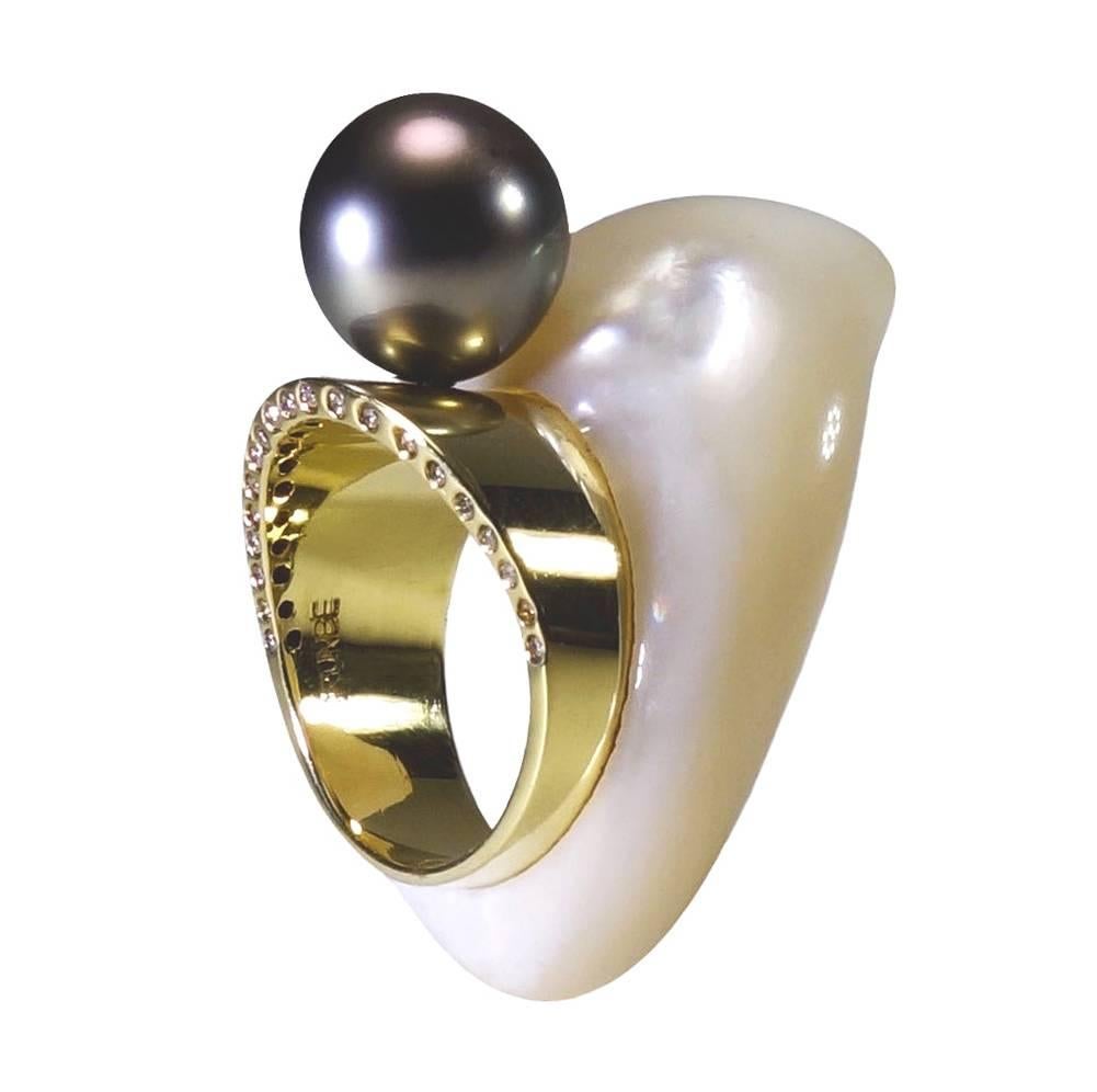 Hand carved mother of pearl with 18K gold band inlaid.  Wearable sculpture on your finger, featured a 12 mm Tahitian pearl sitting on top of an 18K gold band measured 9 mm, accented with round brilliant cut diamonds 0.20 TCW set onto the side half