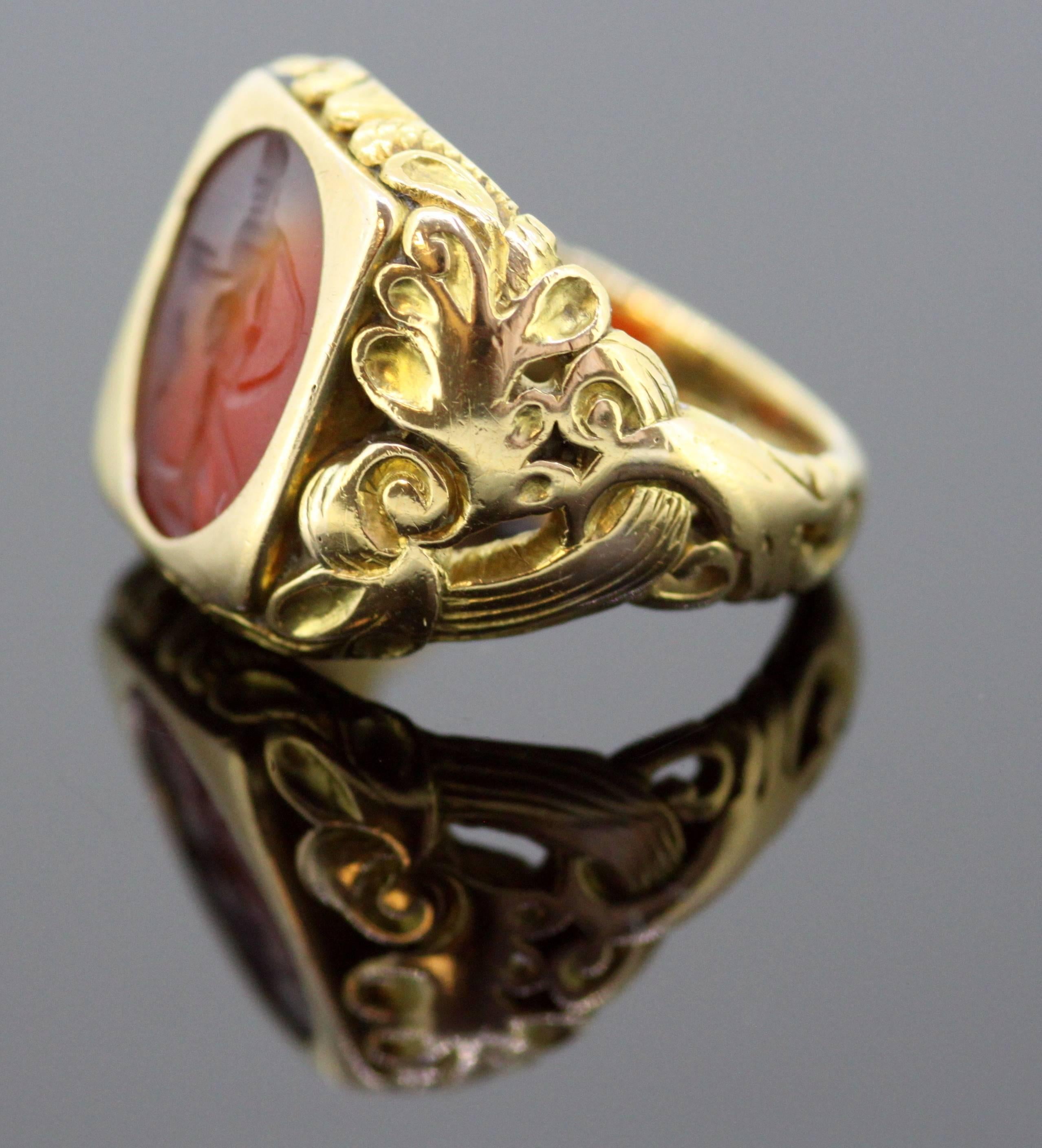 An antique 18K yellow gold ring, with a Roman carnelian seal of the period 200 BC, with added later beautifully engraved shank of the ring which is circa 1940's 

Dimensions - 
Finger Size UK : Q US : 8 1/2 EU: 57 1/2 
Ring Size : 2.6 x 2.4 x 1.9 cm